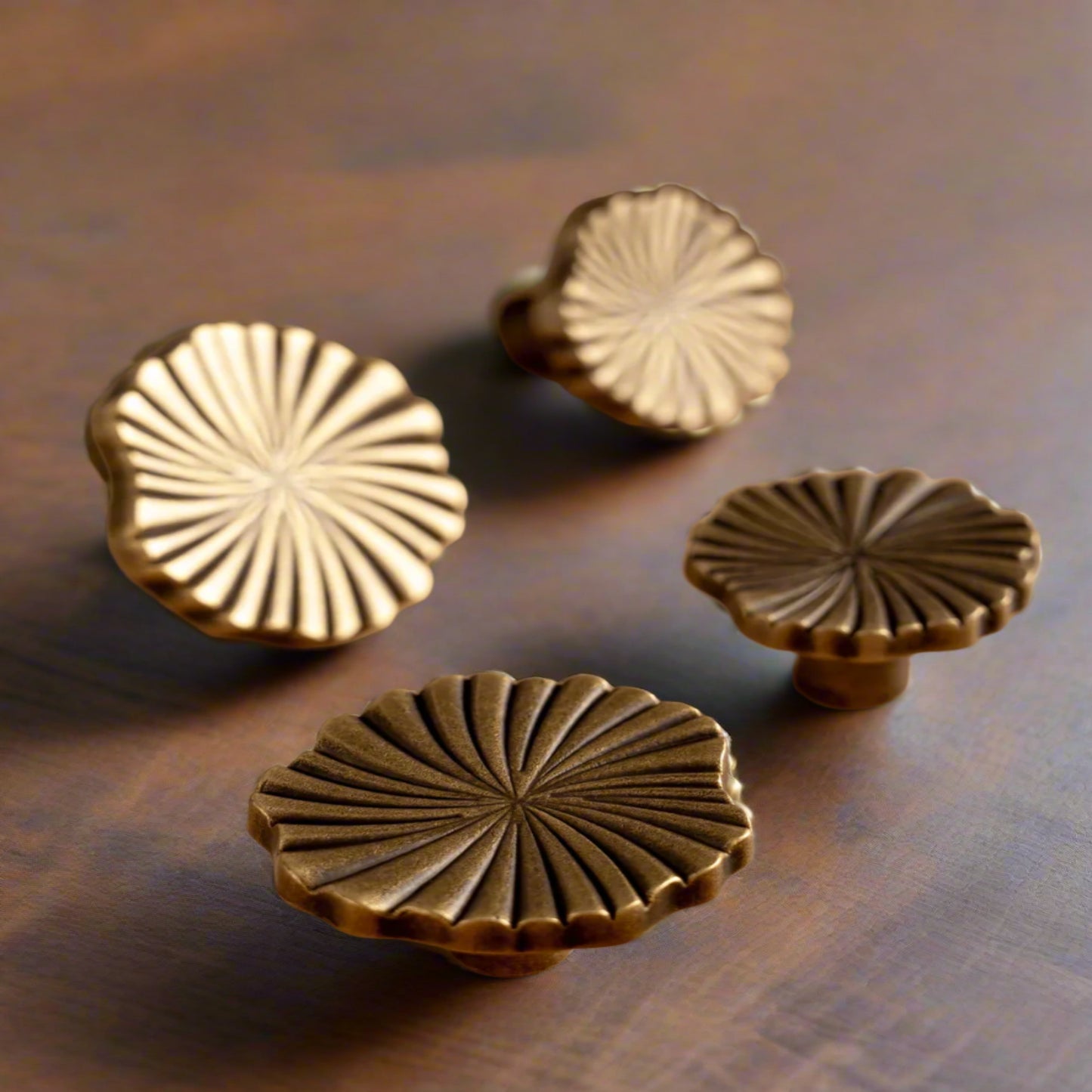 Decorative brass knobs on a wooden surface.