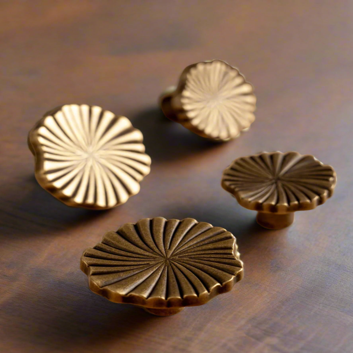 Decorative brass knobs on a wooden surface.