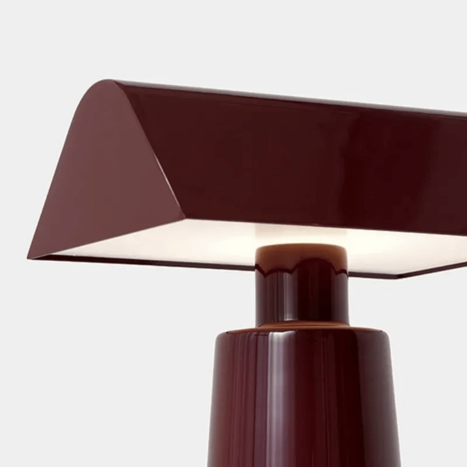 Modern brown table lamp with a geometric design on a light gray background