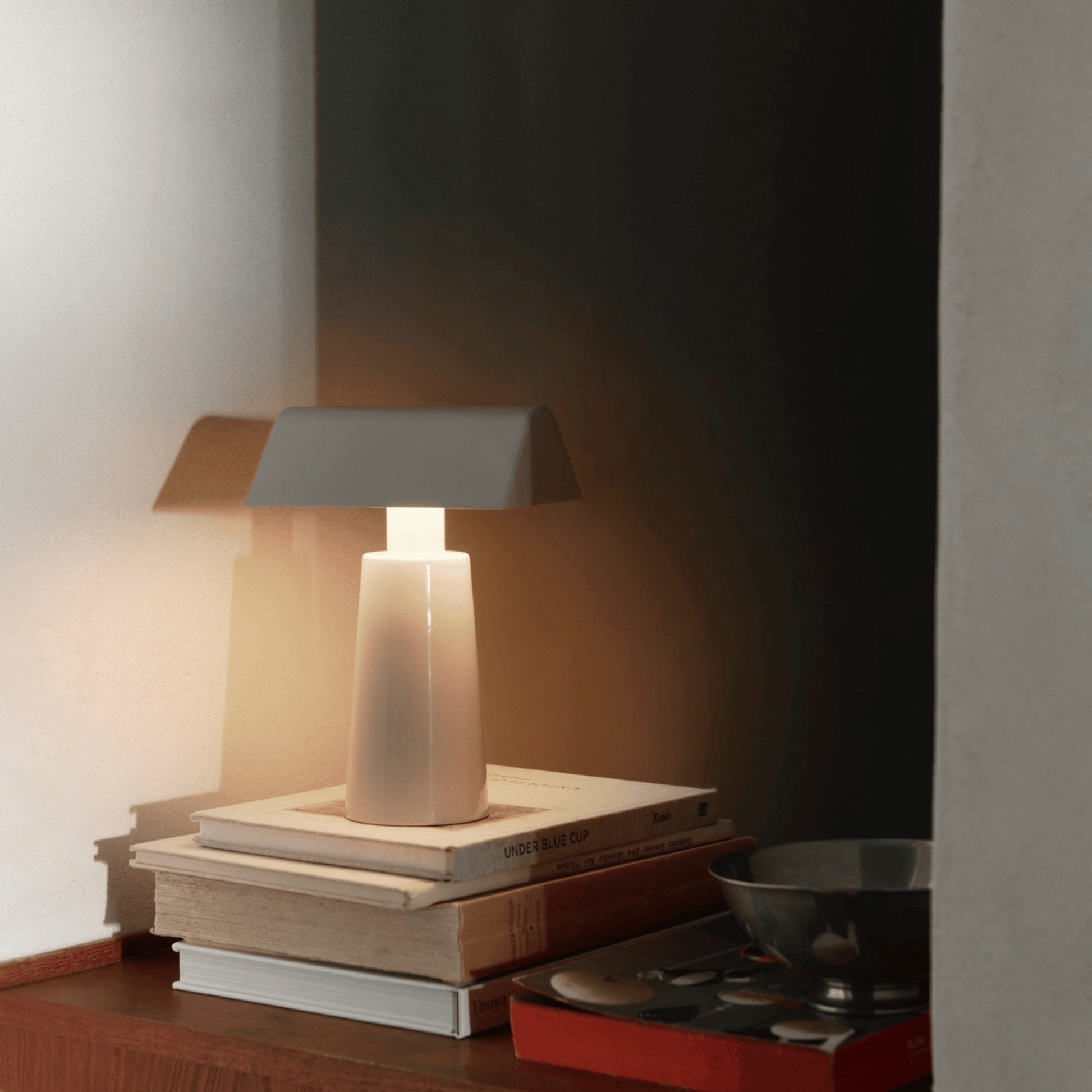 Table lamp on a stack of books with a dark background