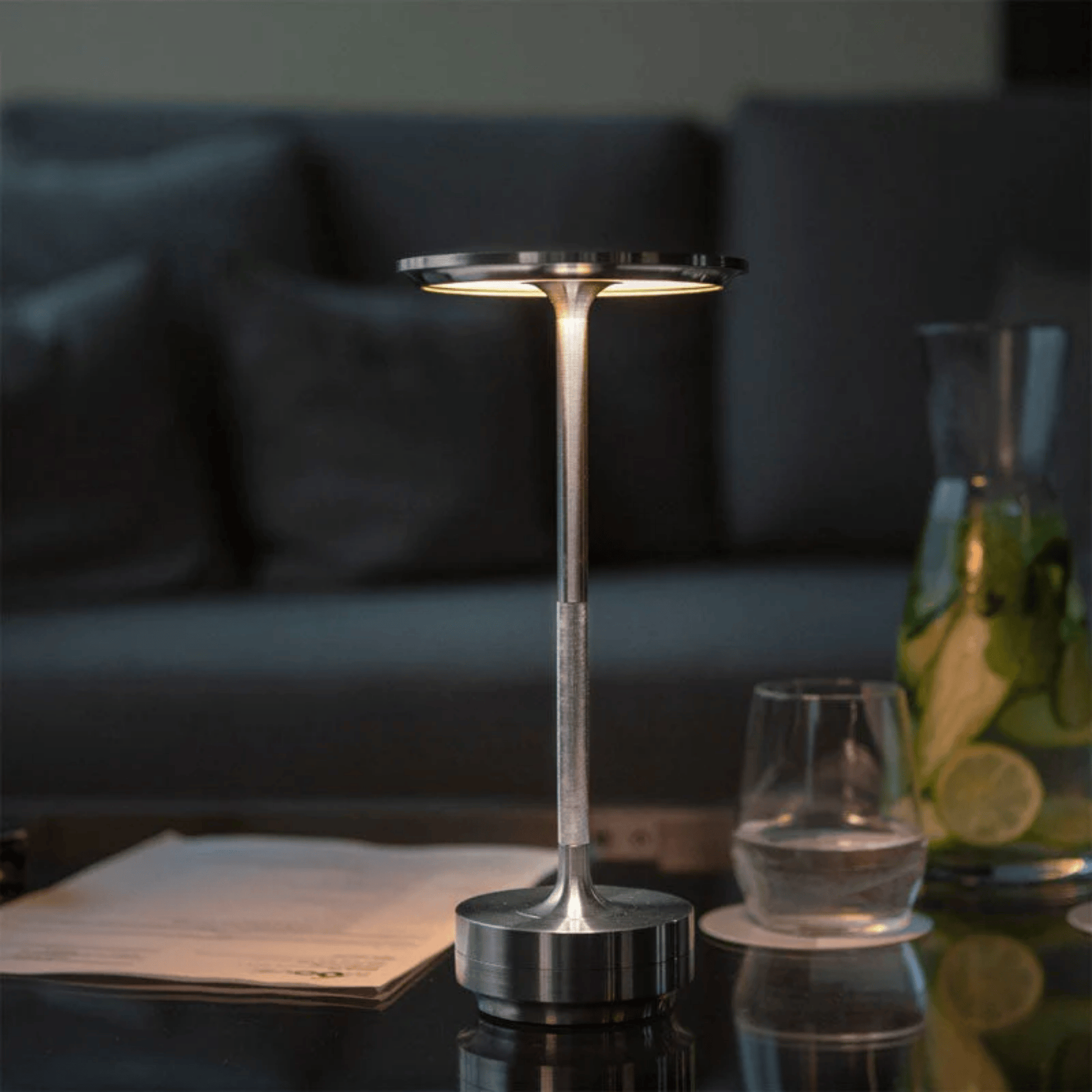 Modern silver lamp on a table with a blurred background