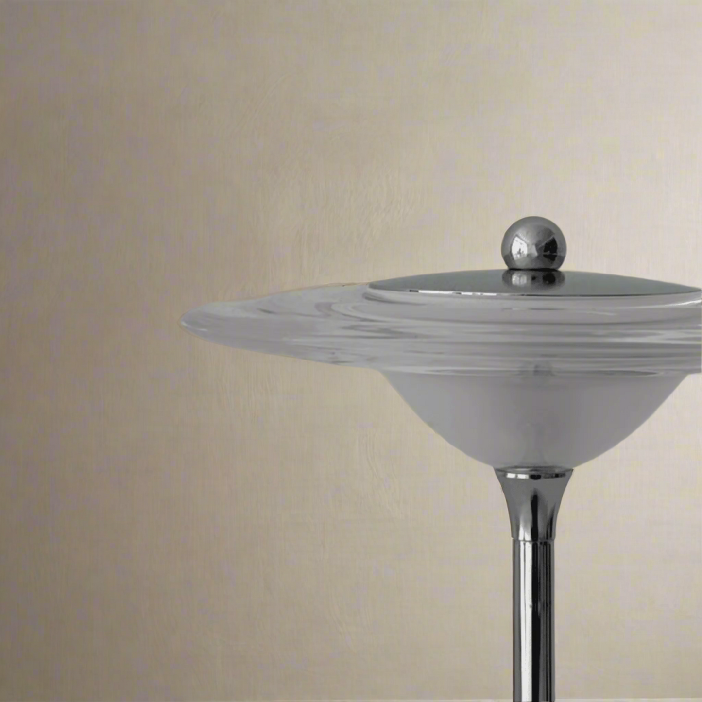 Cylindrical object with a metallic top on a gray background