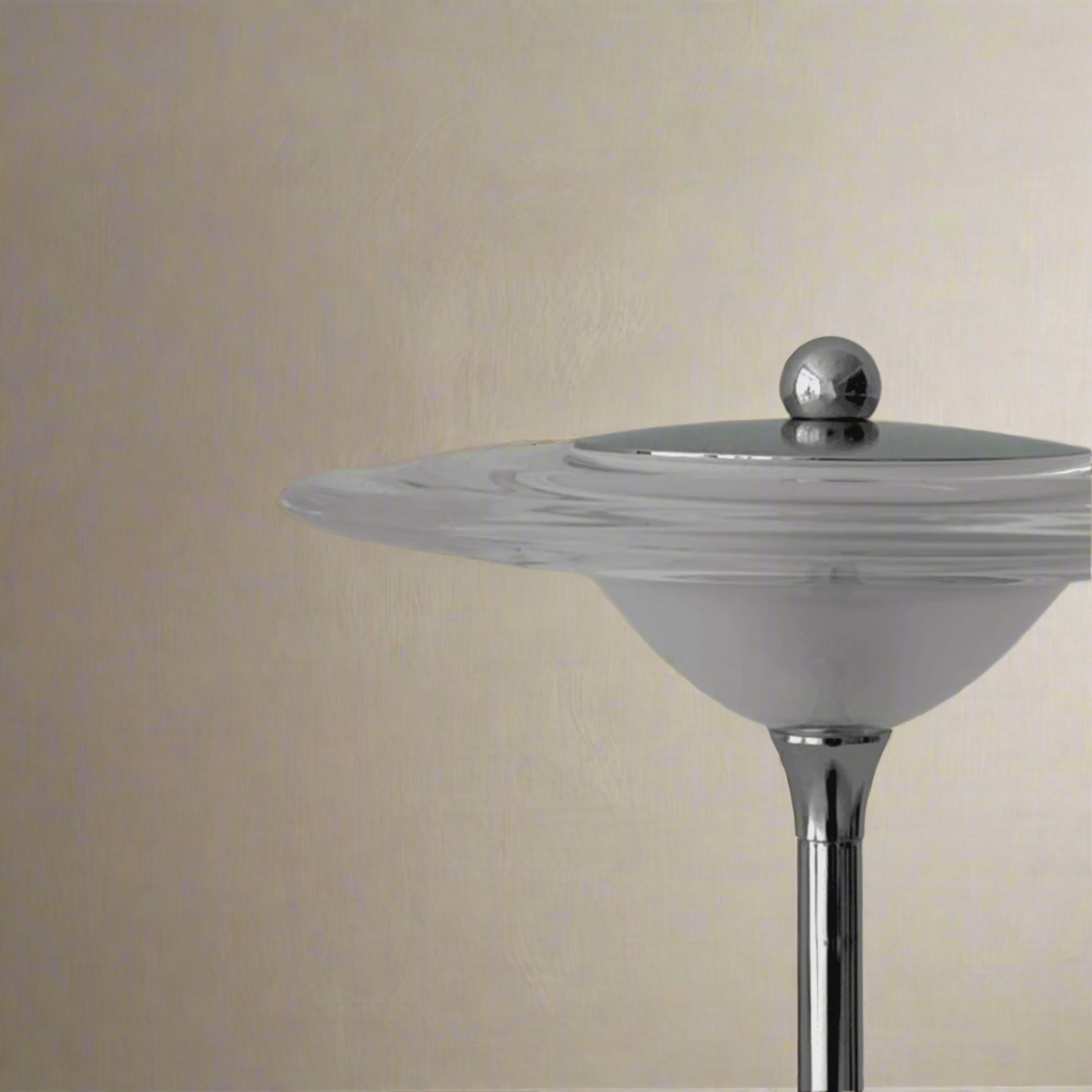 Cylindrical object with a metallic top on a gray background