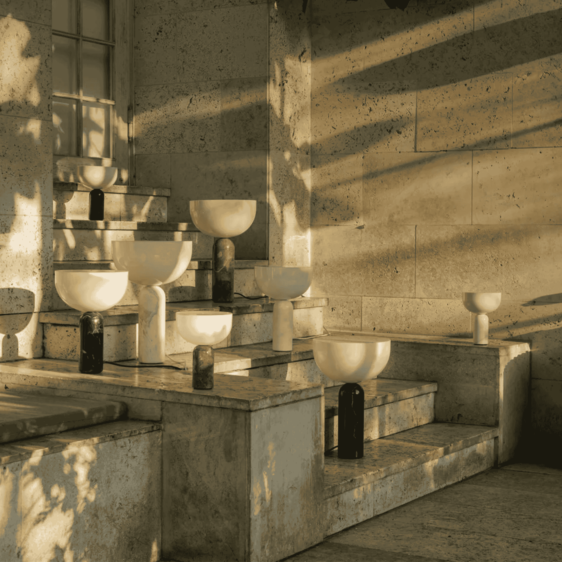 Art installation with abstract sculptures in a sunlit room.