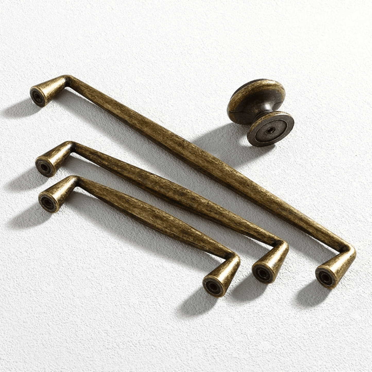 Set of bronze cabinet handles on a white background