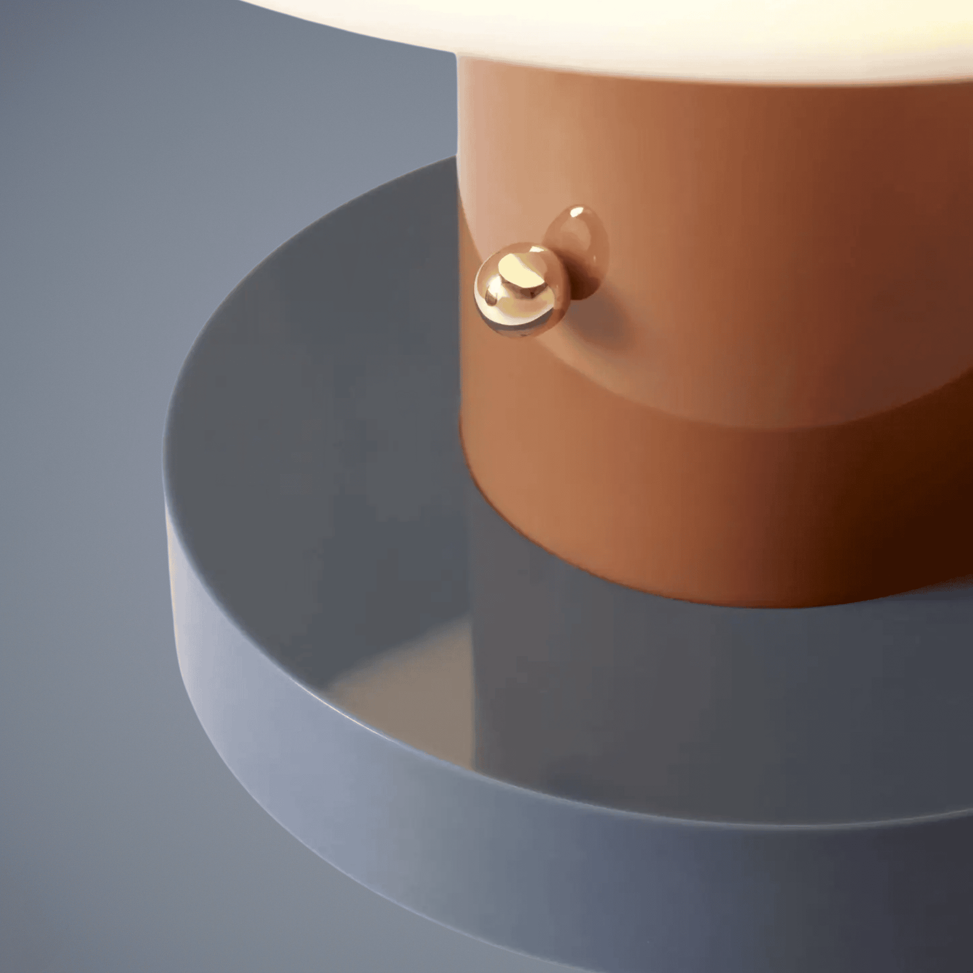 Close-up of a brown cylindrical object with a gold accent on a gray background