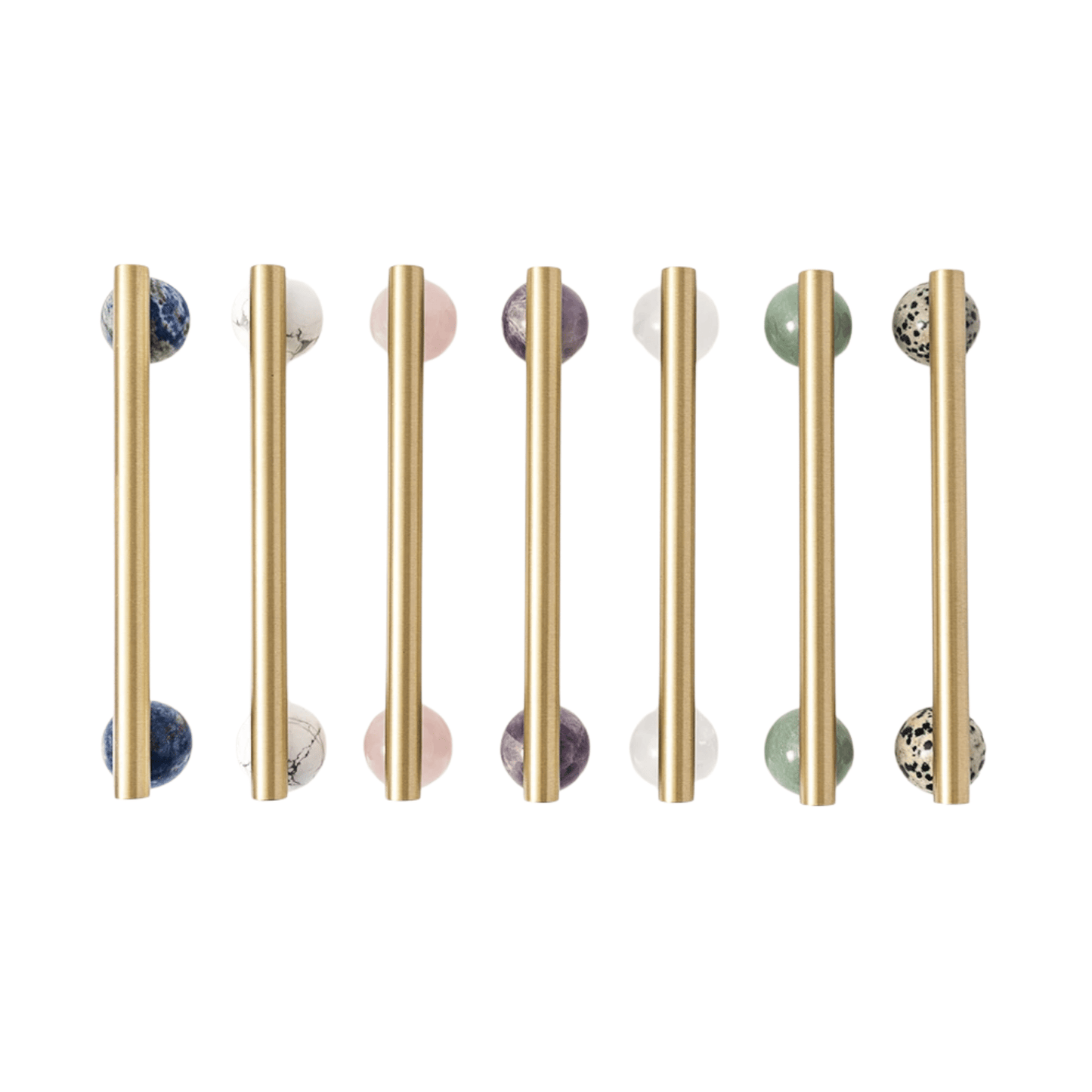 Set of gold cabinet handles with marble knobs on a white background