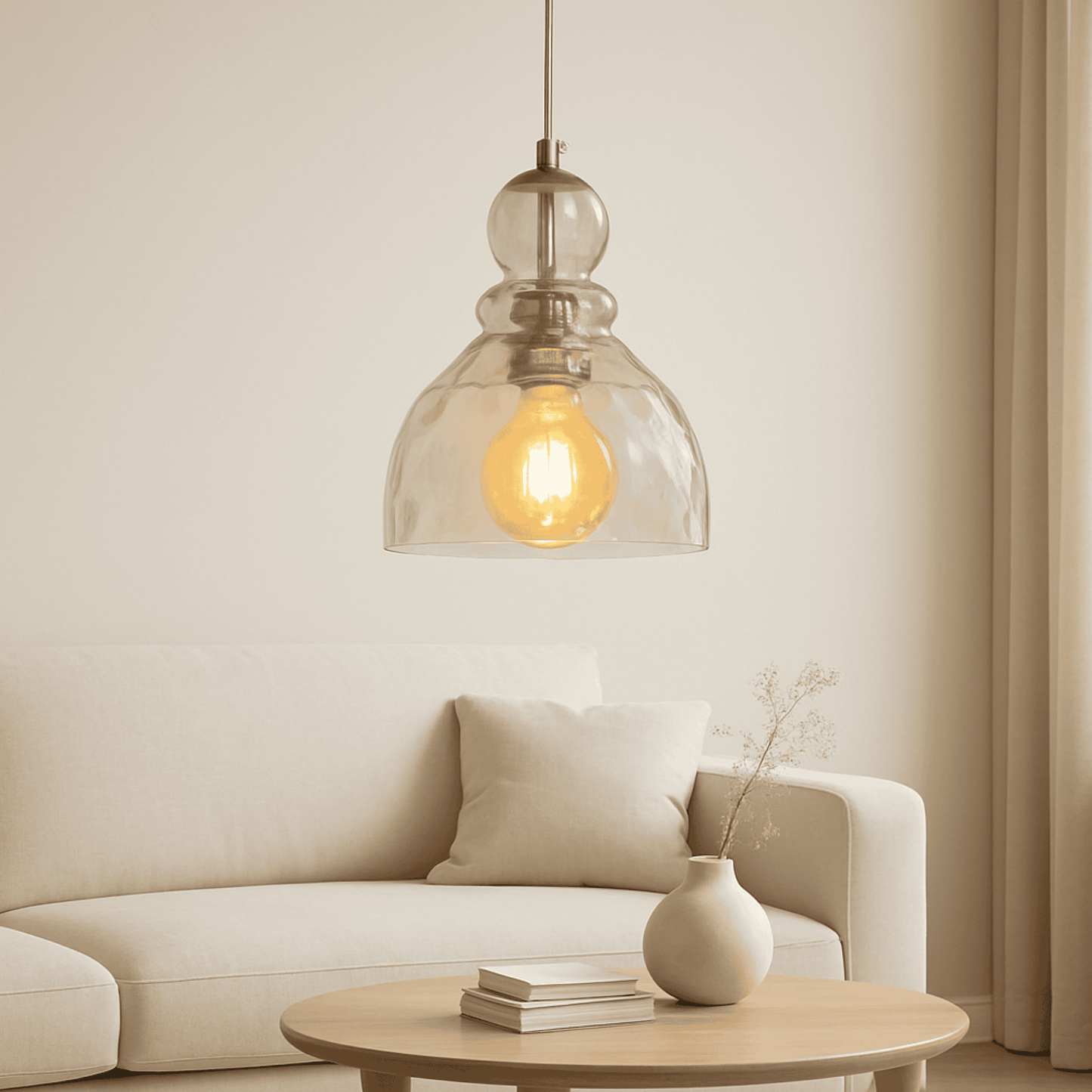 Modern pendant light hanging above a sofa in a living room setting.