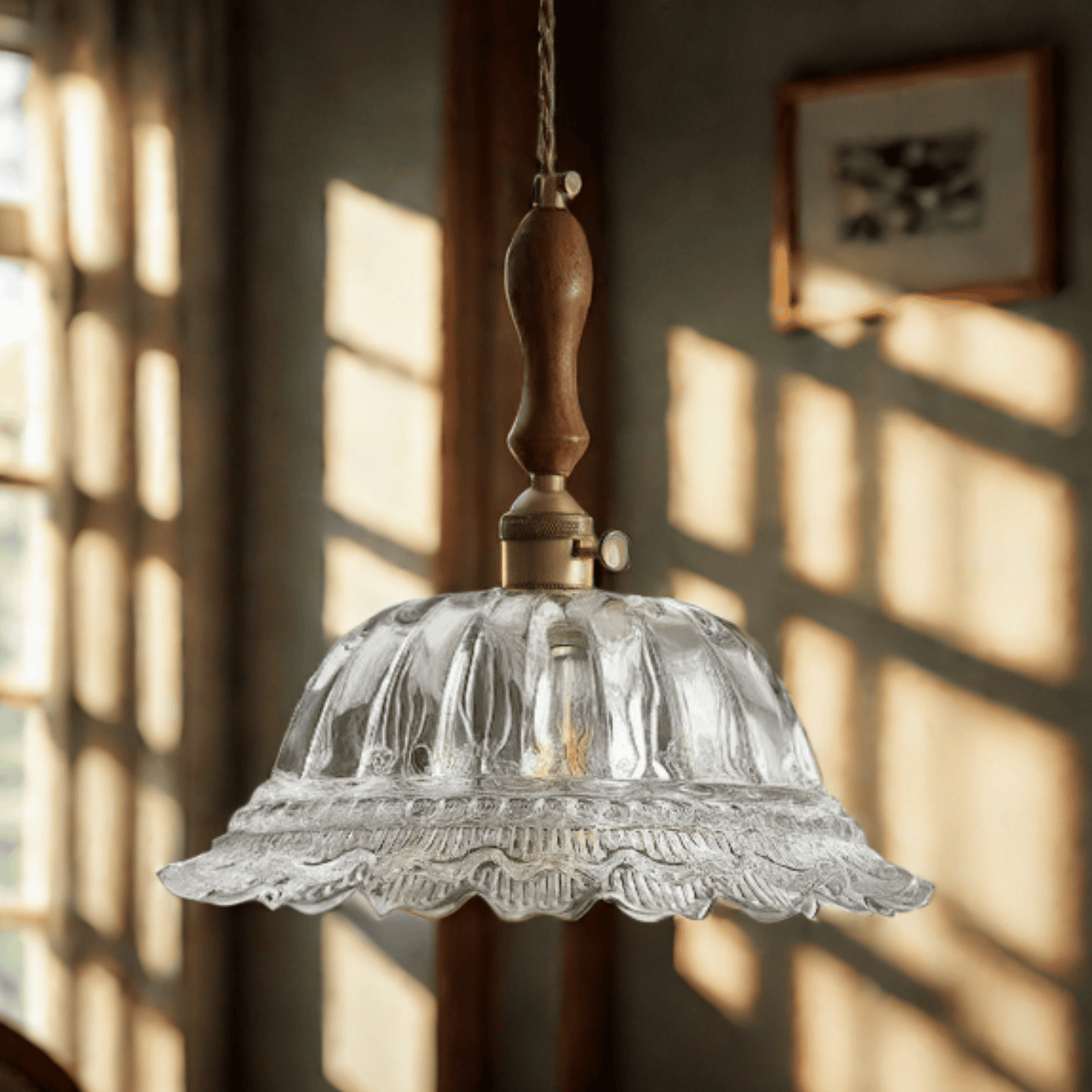 Vintage-style pendant light with clear glass shade and wooden fixture hanging in a room with sunlight filtering through.