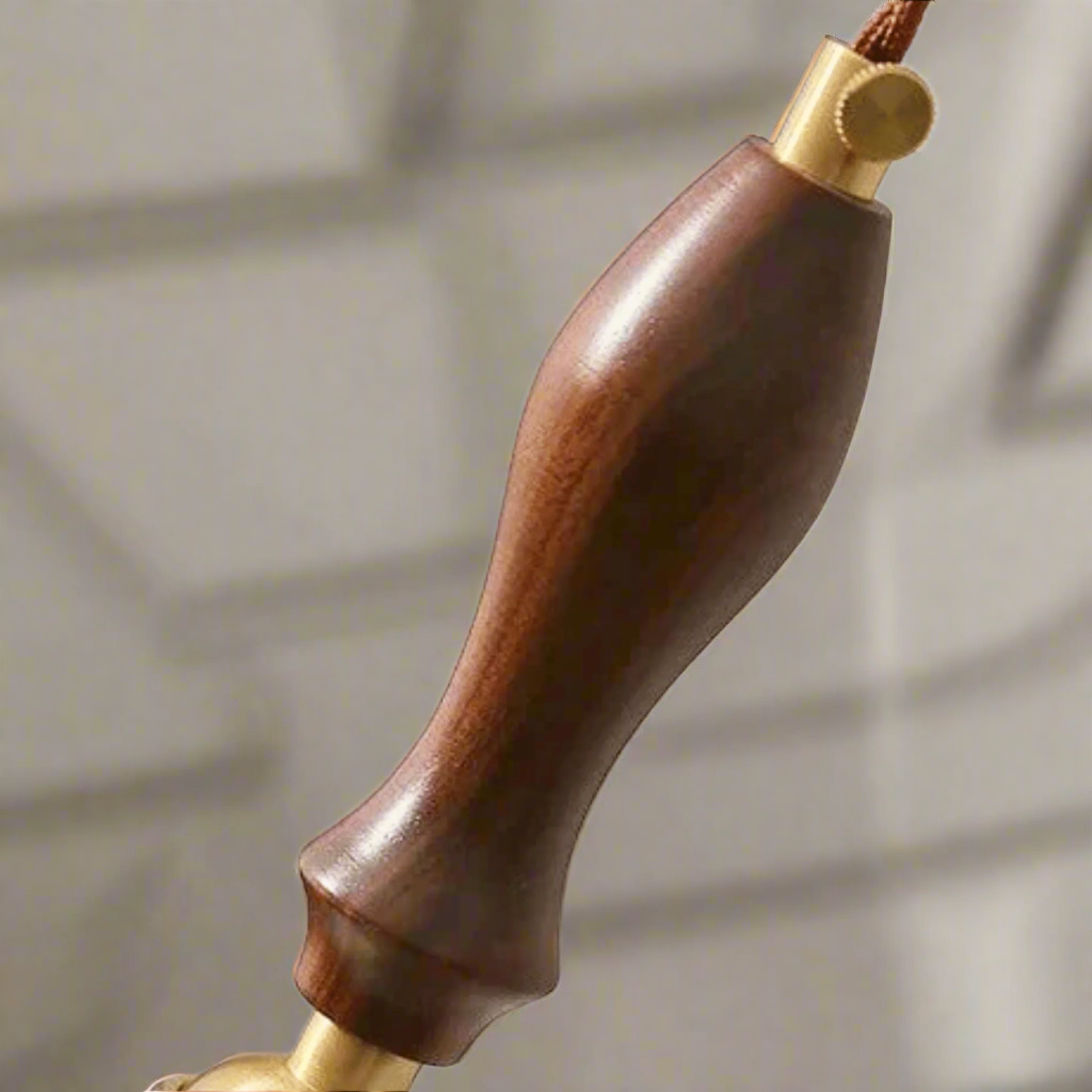 Wooden handle with gold accents on a gray background