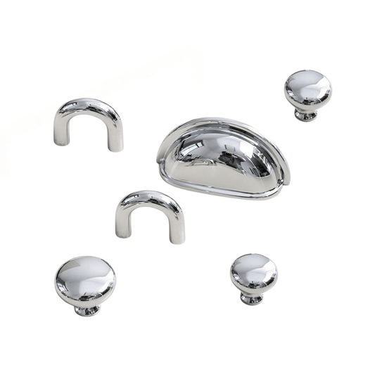 Set of chrome cabinet handles and knobs on a white background