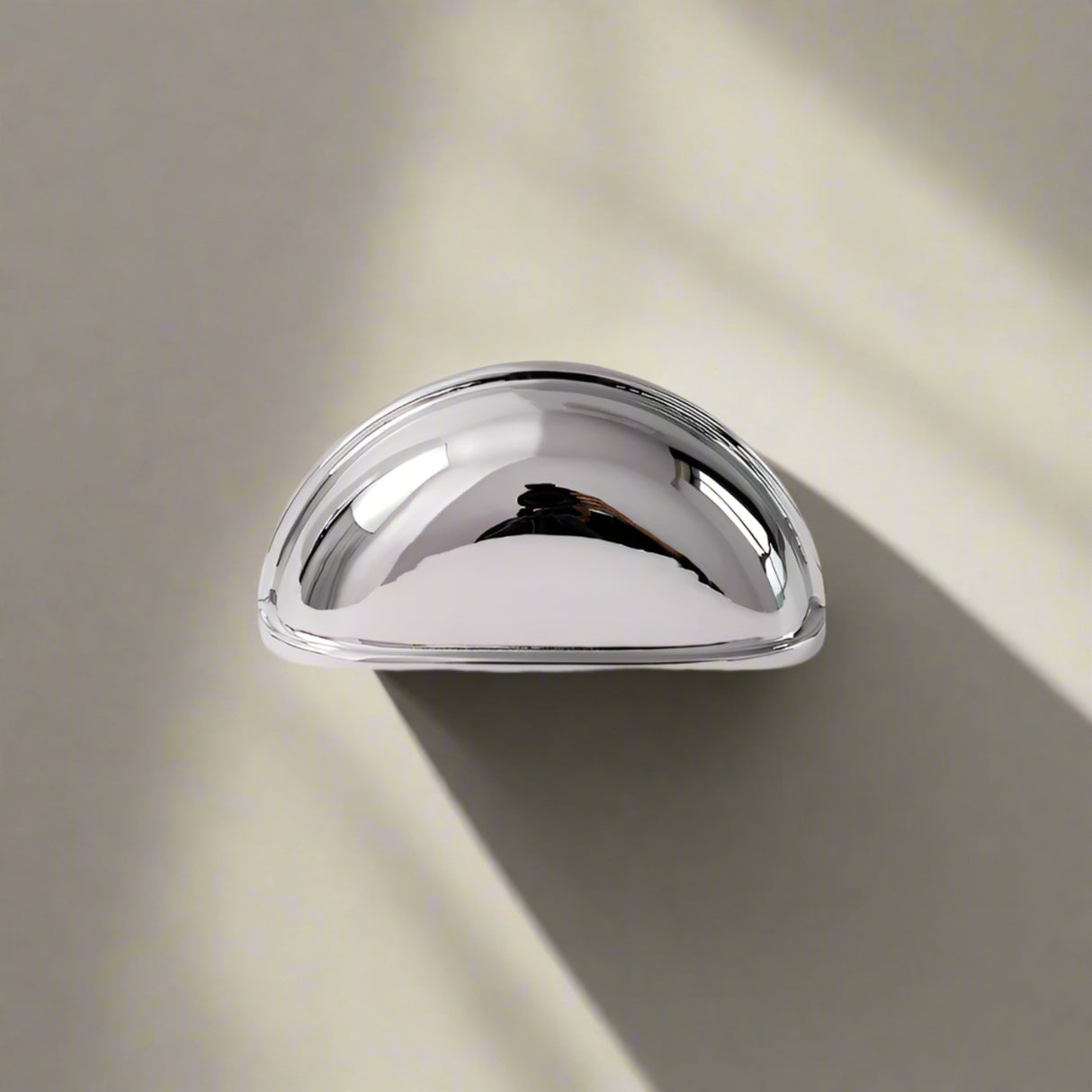 Chrome cabinet handle on a white background