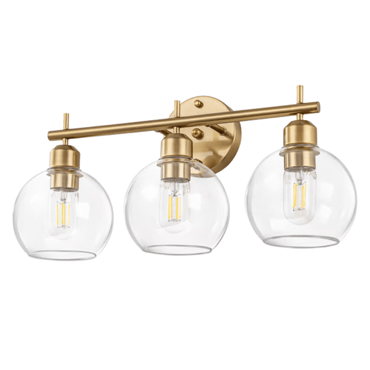 Three-light wall sconce with gold fixtures and clear glass shades on a white background