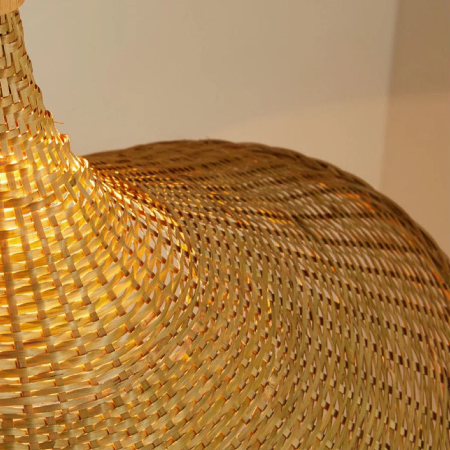 Close-up of a woven straw bag with a plain background
