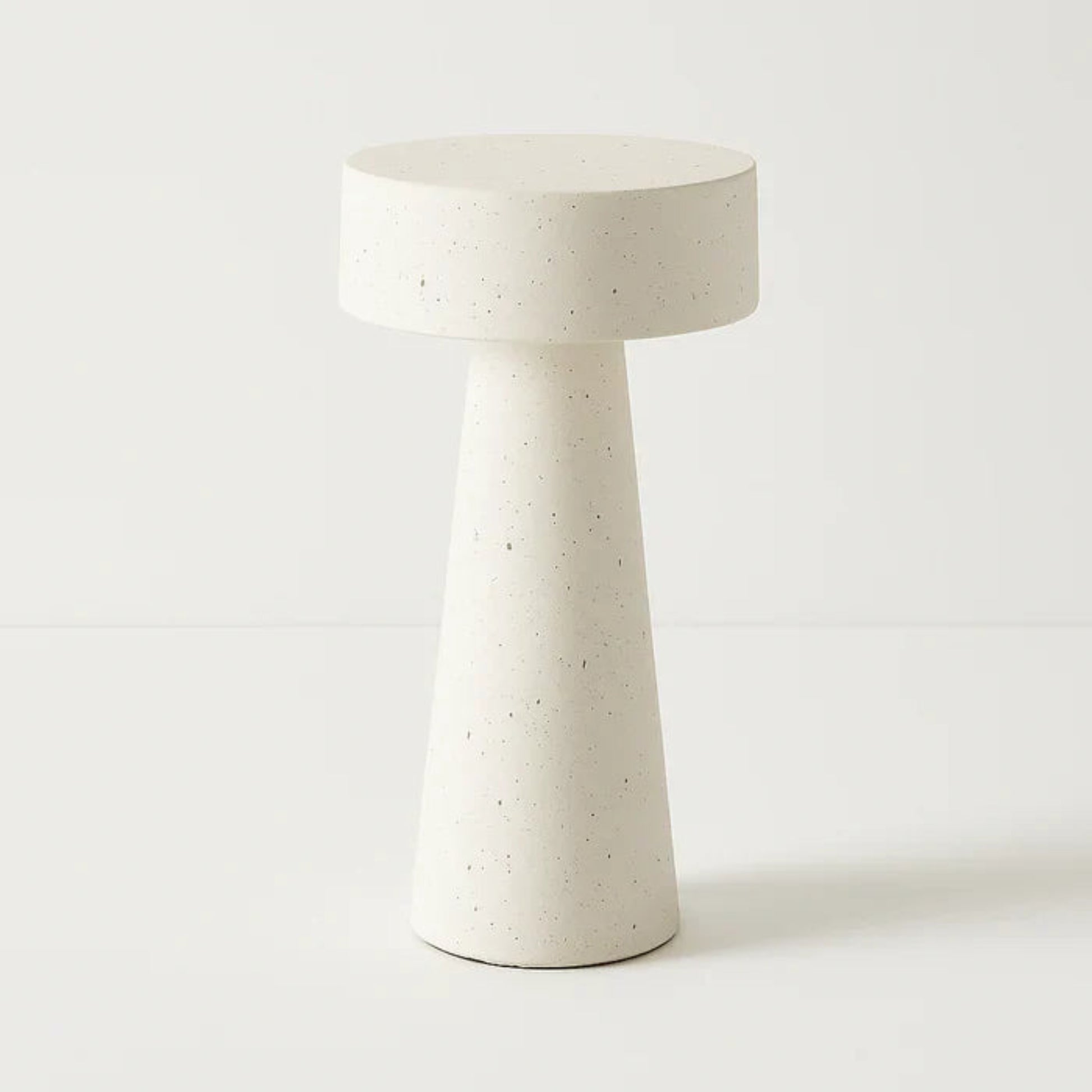 Concrete side table with a textured surface on a white background