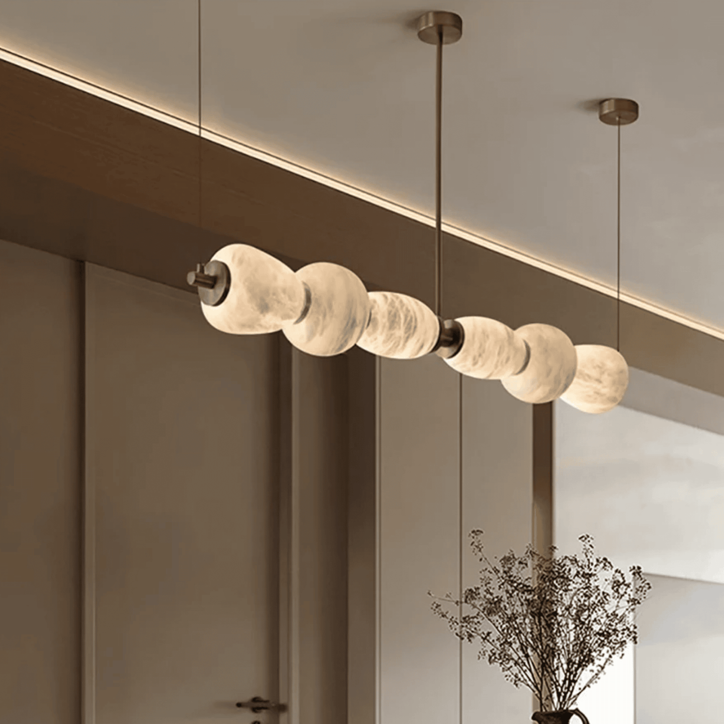 Modern pendant light fixture with marble-like finish in a minimalistic interior setting.