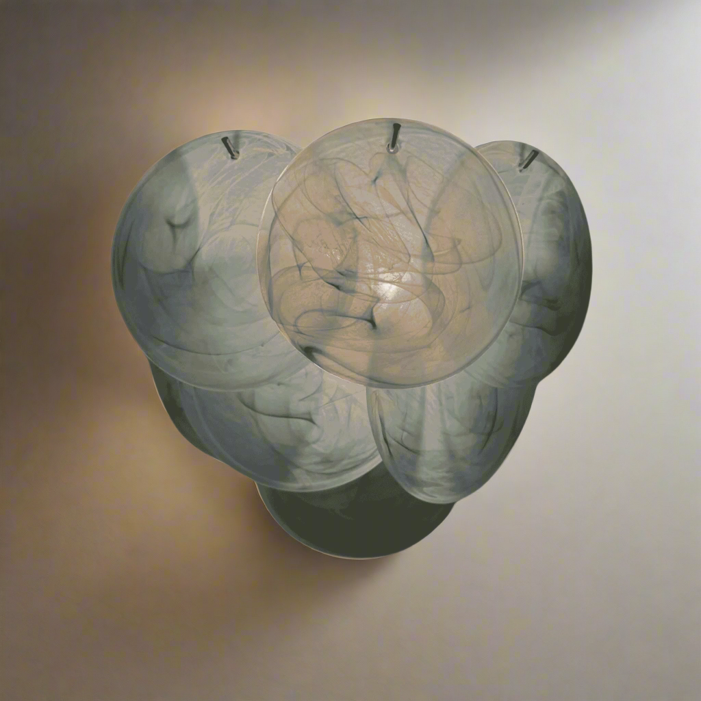 Decorative wall sconce with a marble-like finish on a textured beige background