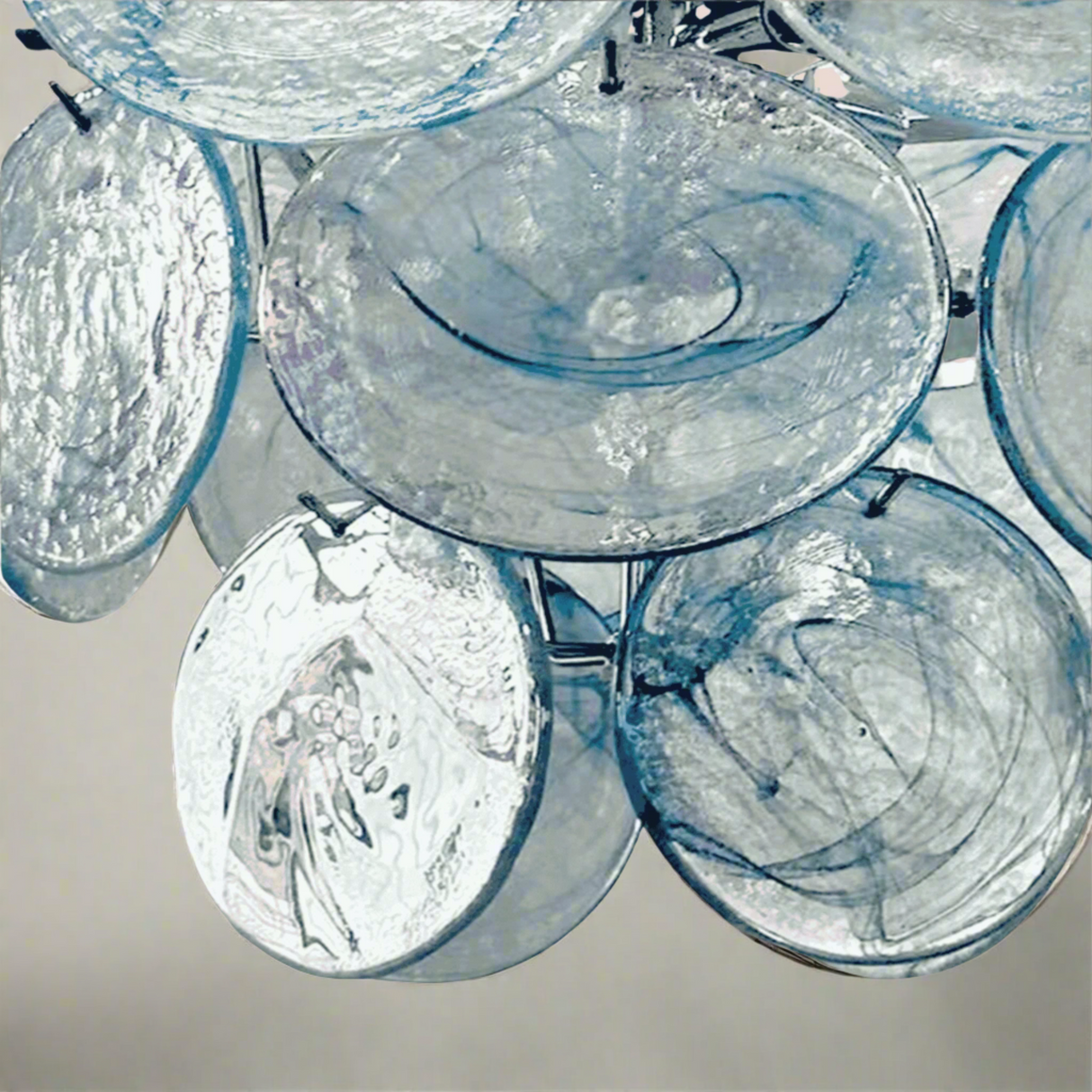 Close-up of a chandelier with glass shades on a light pink background