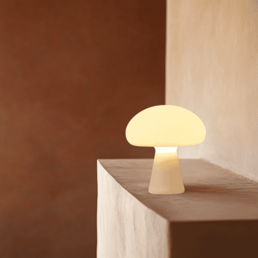 Mushroom-shaped lamp on a wooden surface with a warm glow