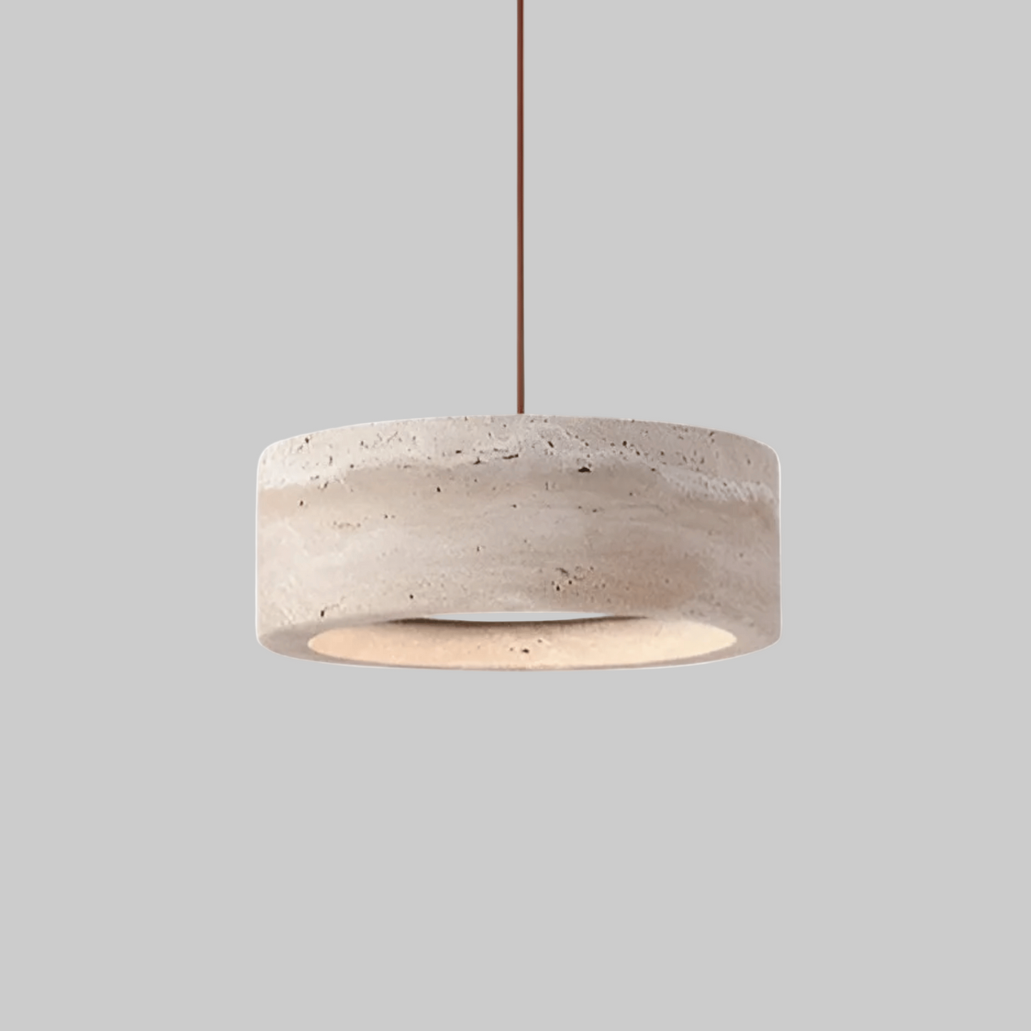 Ithaca LED Pendant Light in natural travertine stone with a minimalist round design, ideal for modern ceiling lighting in home interiors.