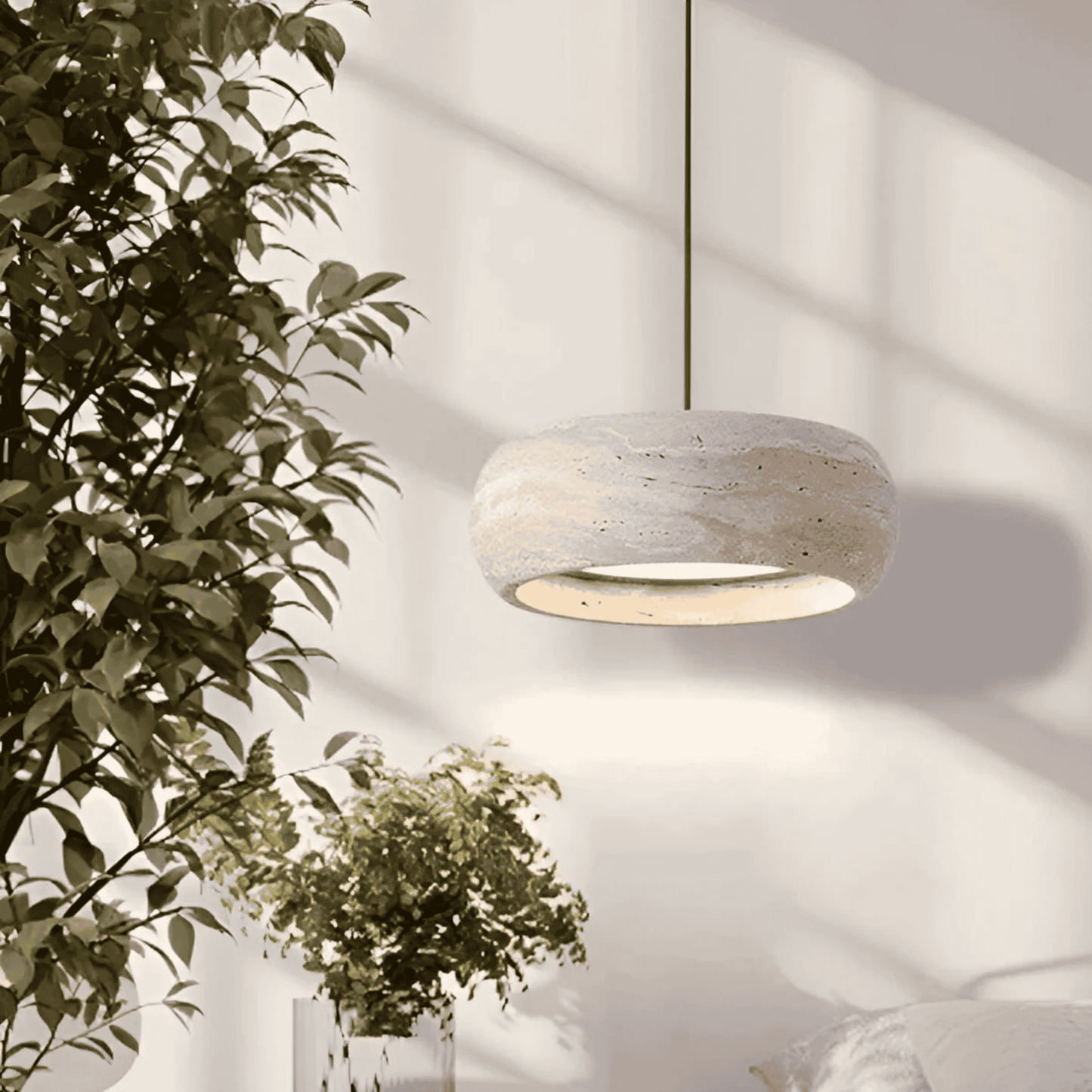 Ithaca travertine LED pendant lamp suspended in a bright bedroom setting, offering dimmable lighting for cozy and elegant ambiance.