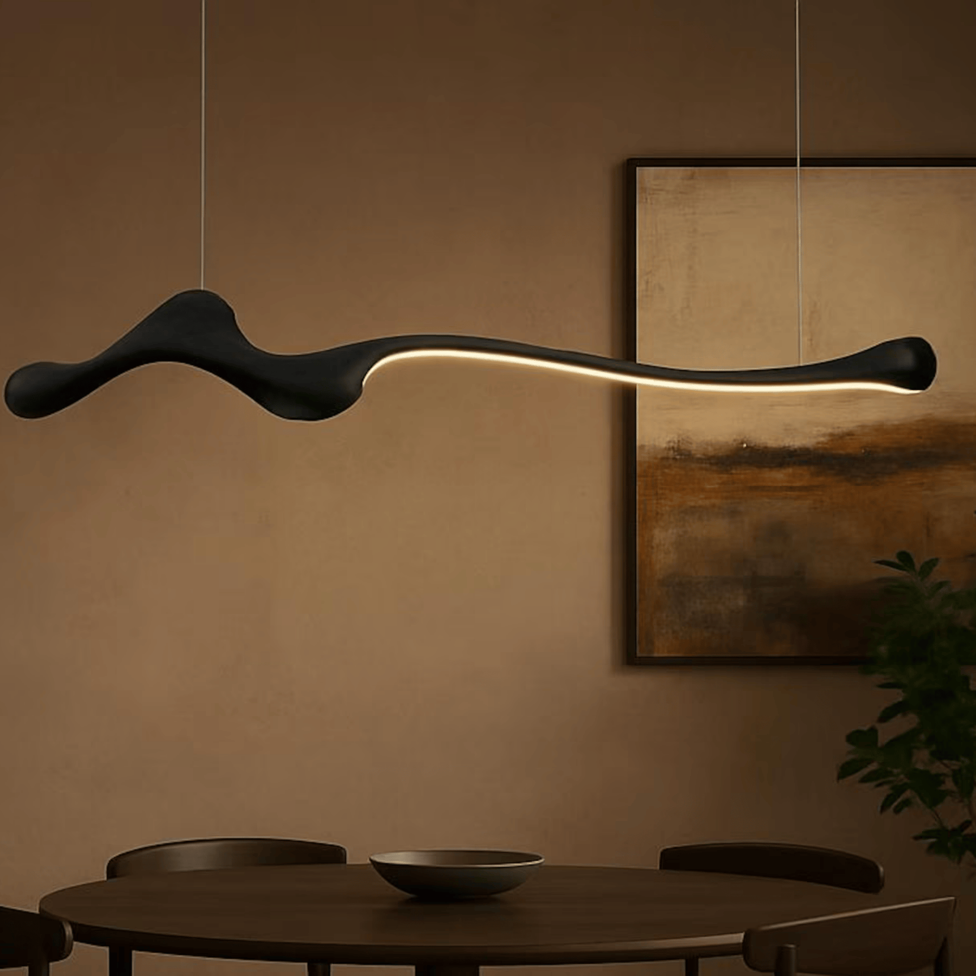 Black ZenRay Ashwood Pendant Light glowing warmly in a modern dining room, emphasizing its sculptural and dimmable LED design.