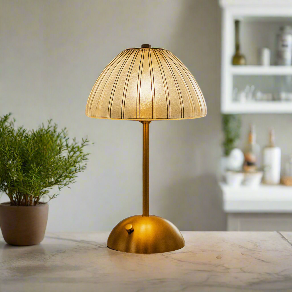 Gold table lamp with a textured shade on a white background