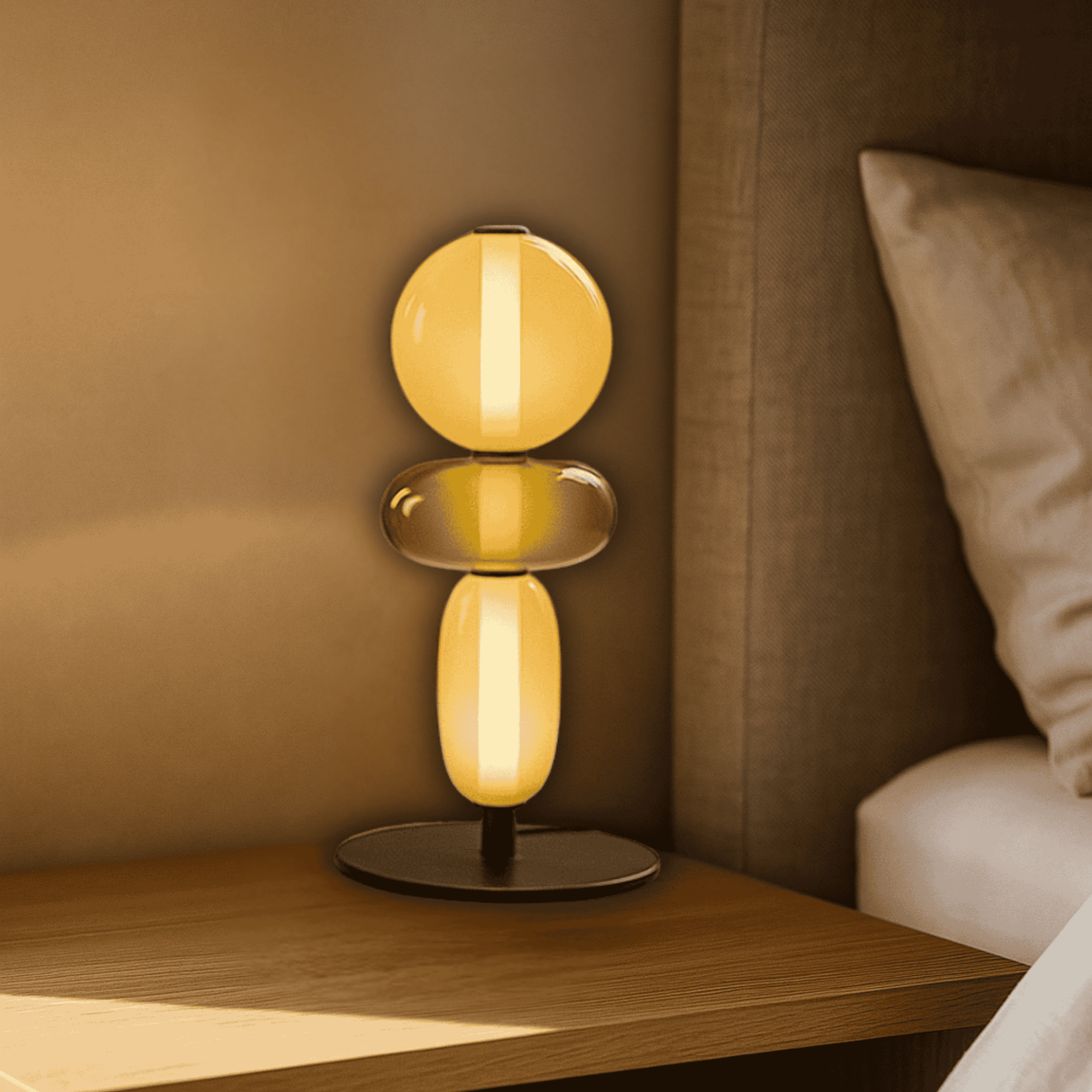 Modern table lamp with two glowing yellow shades on a wooden nightstand.