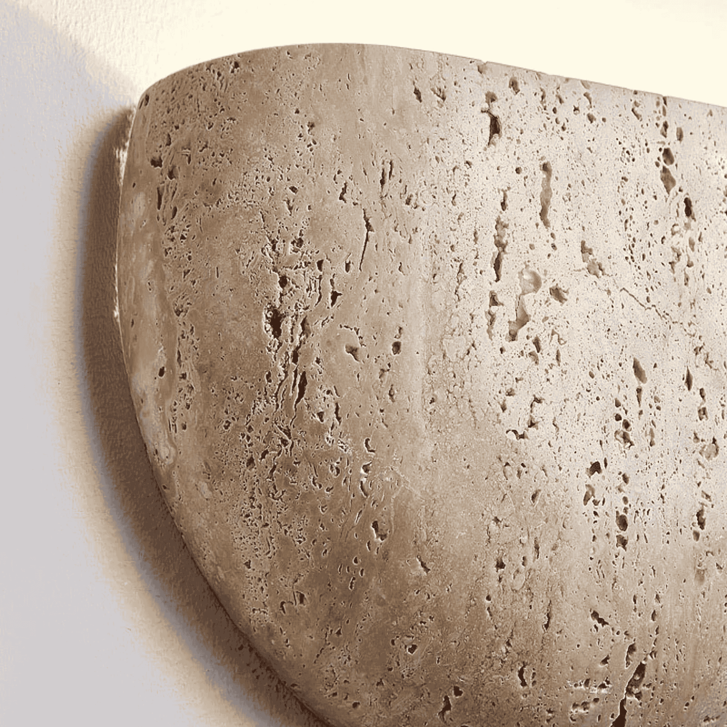Close look at Wall-mounted natural stone sconce emitting soft light