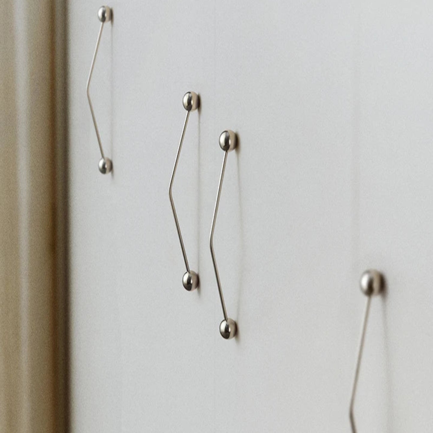 Silver door hanldes on a light gray background.