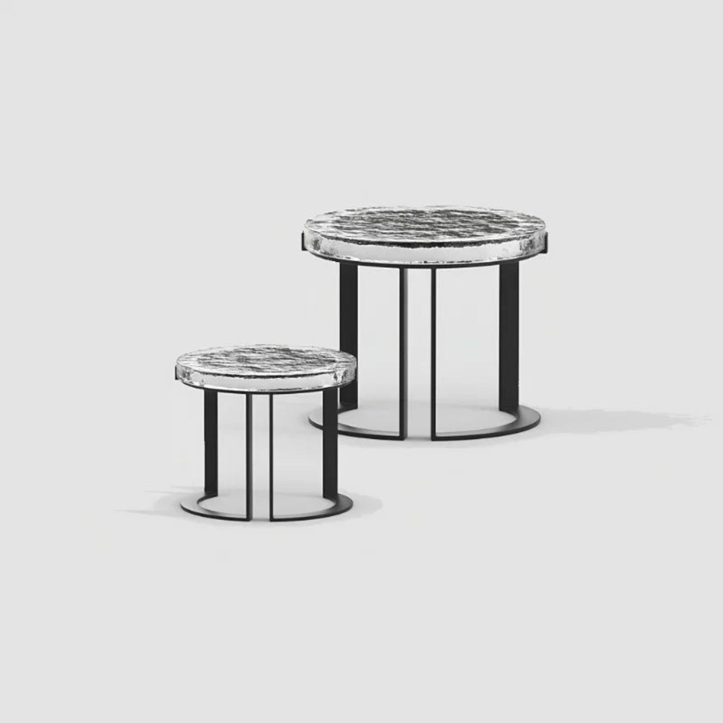 Two round side tables with marble tops and black metal bases on a light gray background