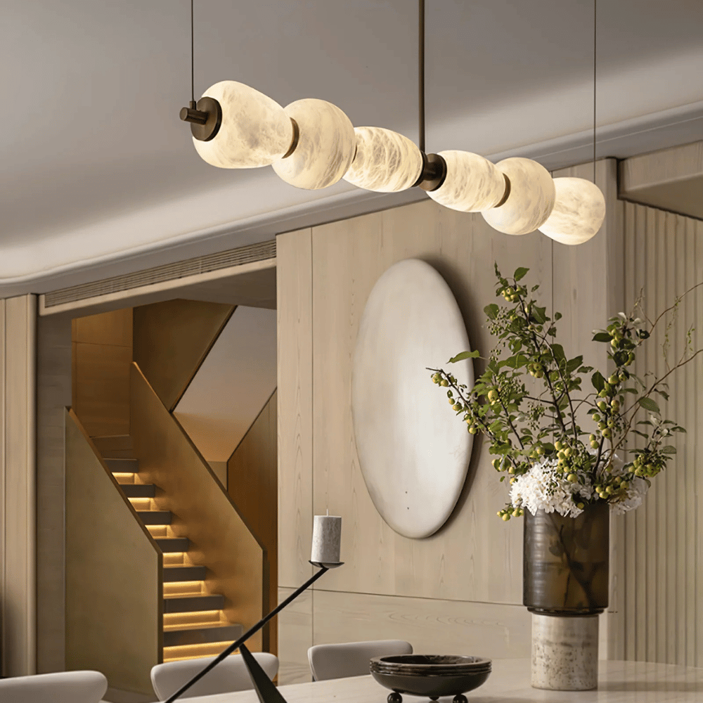 Modern interior design with a chandelier, mirror, and decorative elements.