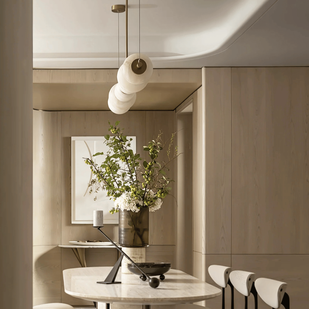 Modern interior with a round table, chairs, and decorative elements.