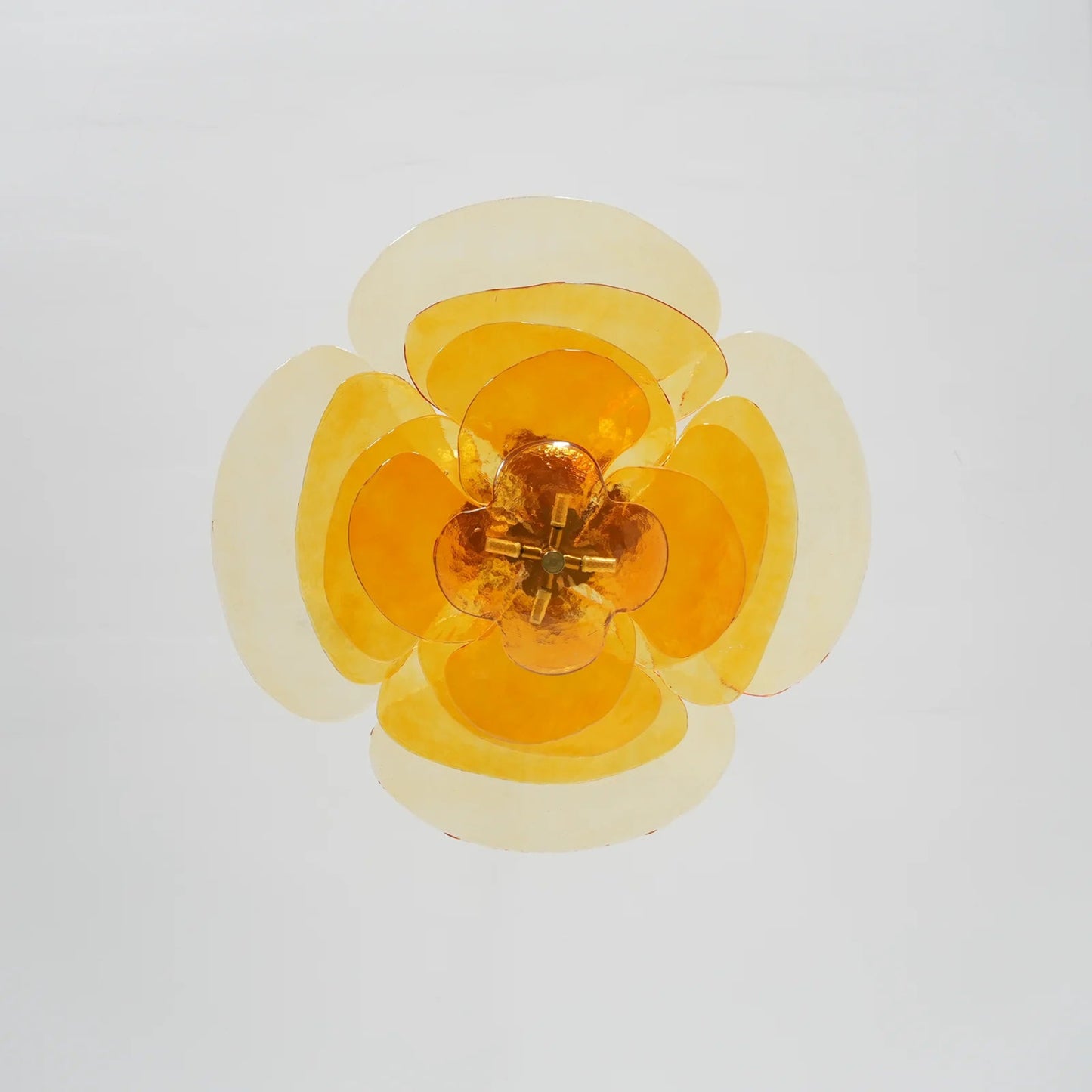 Yellow flower-shaped ceiling light on a light gray background