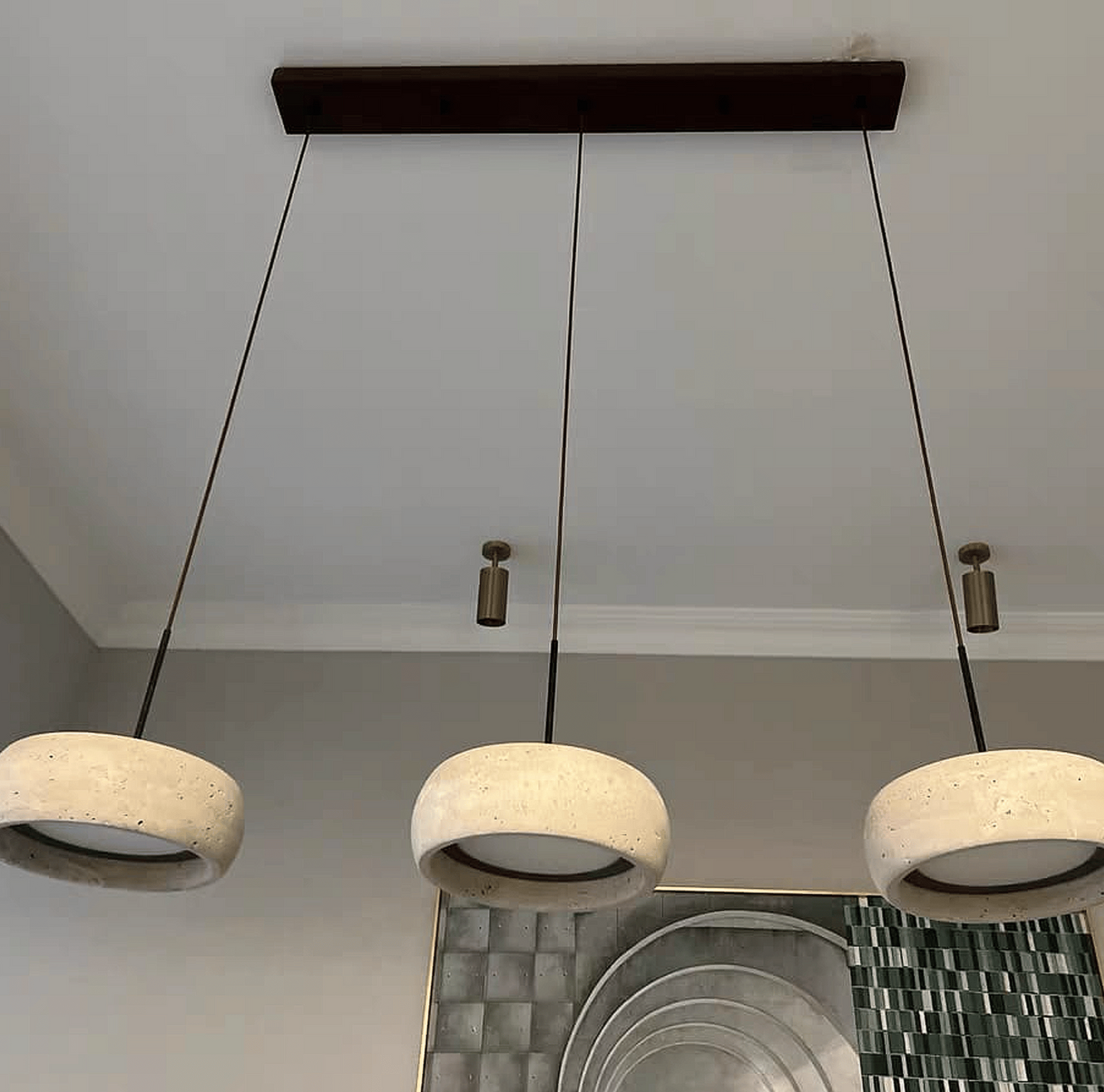 Three concrete pendant lights hanging from a ceiling