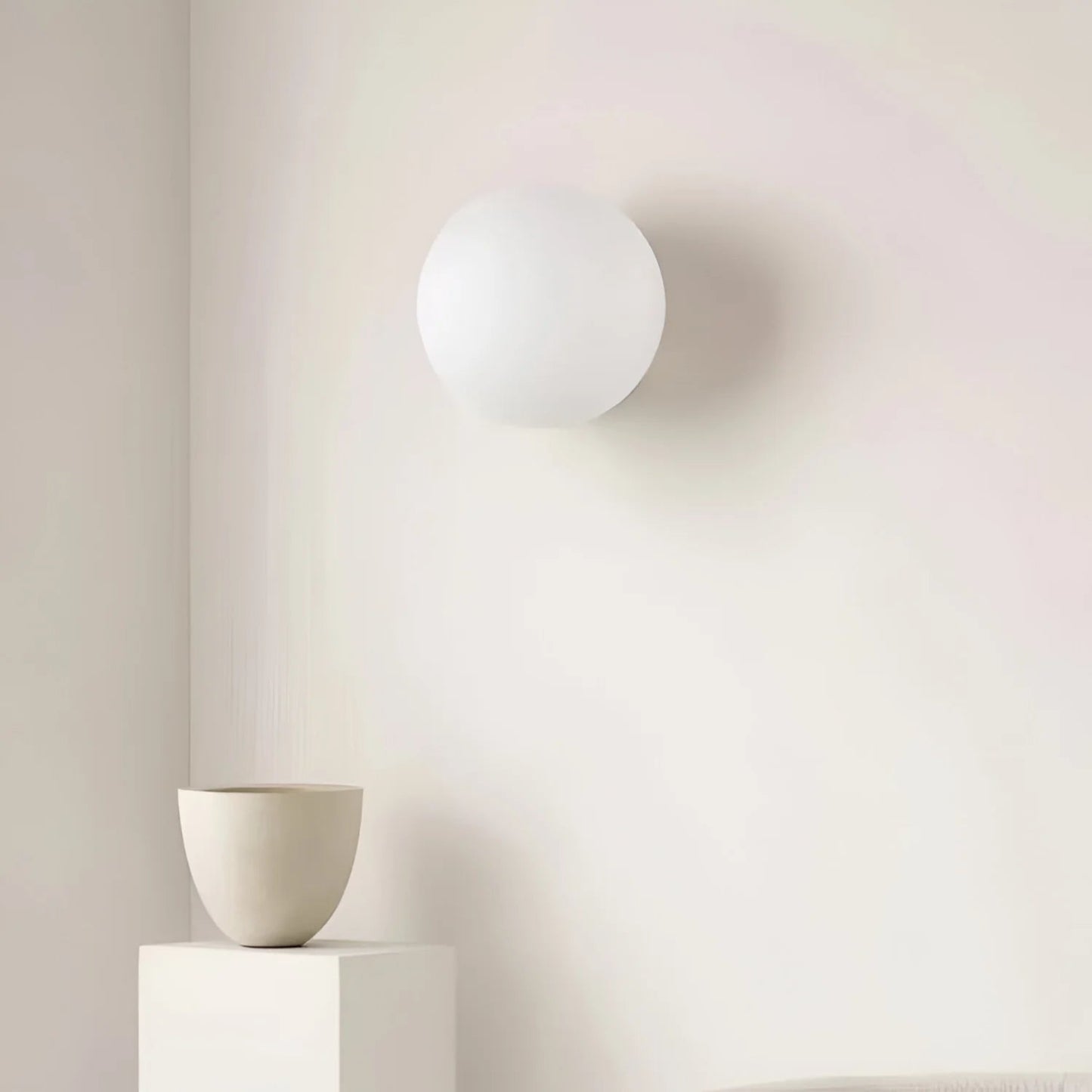White spherical light fixture on a neutral background