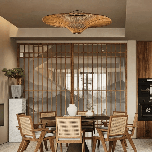 Dining area with wooden chairs, table, and decorative elements in a modern interior setting.