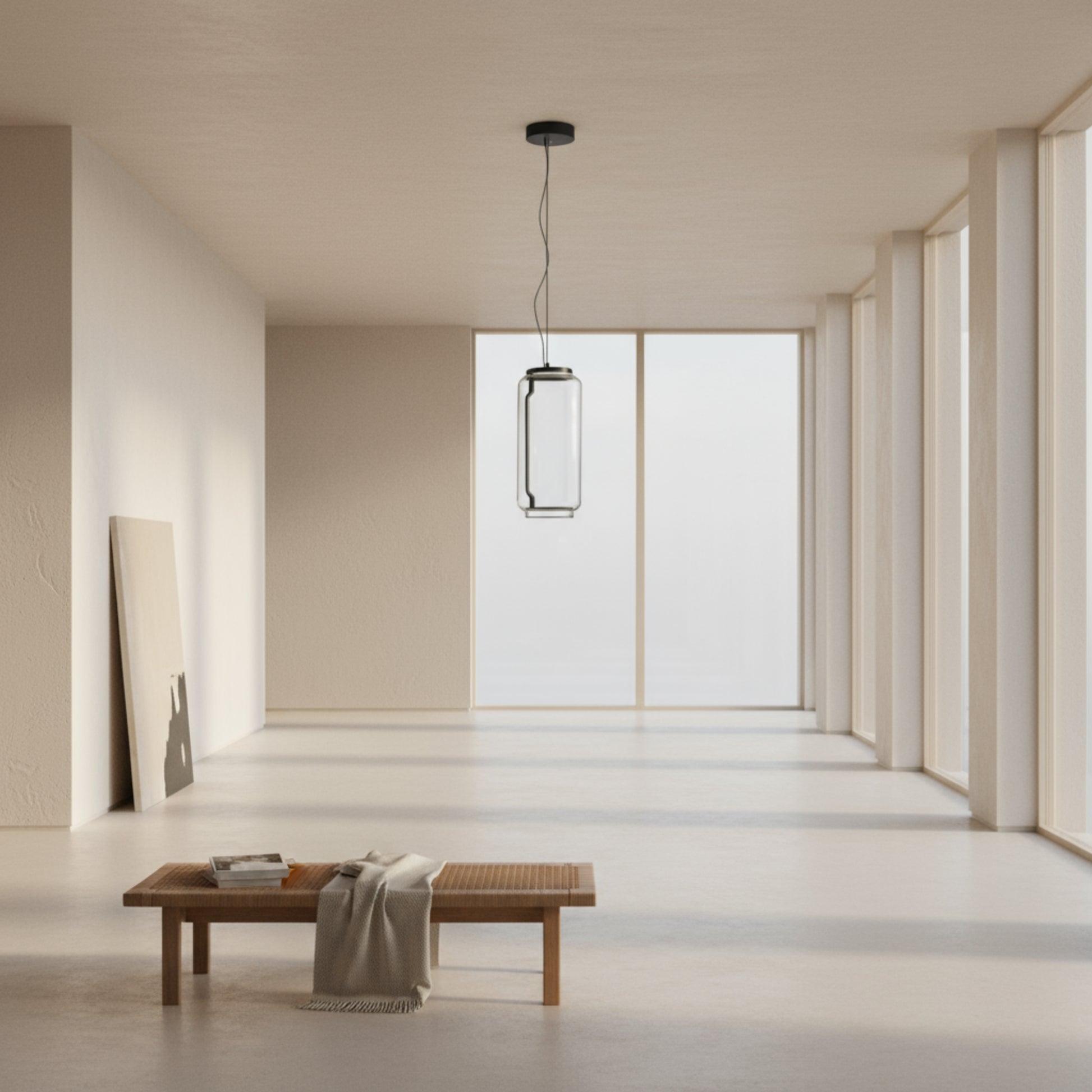 Modern pendant light with cylindrical glass shade on a gray background