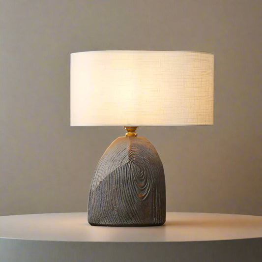 Table lamp with wooden base on a white backround