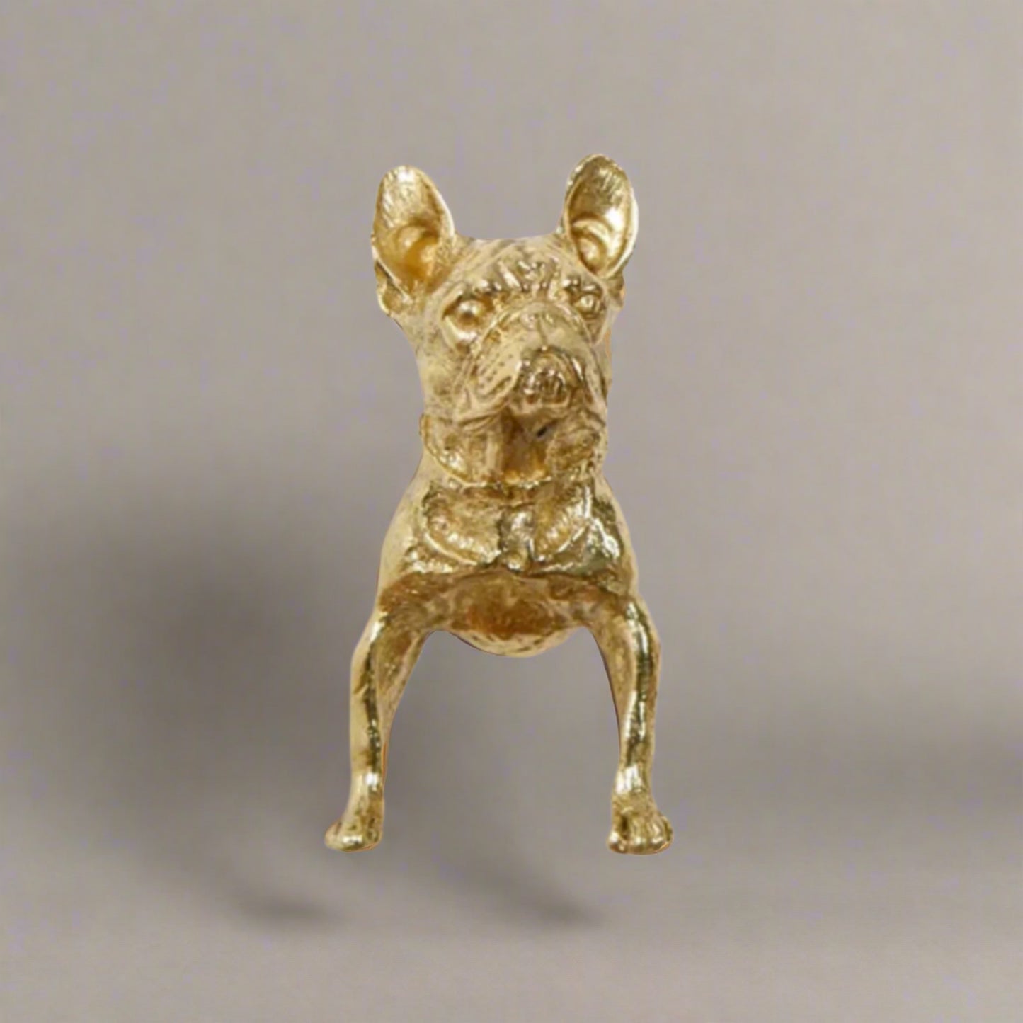 Gold dog figurine on a white background