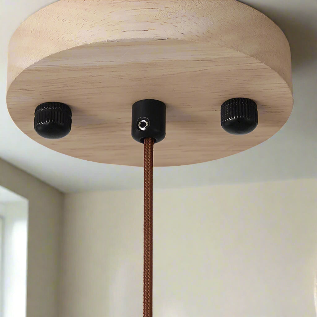 Wooden lamp base with black connectors on a white background