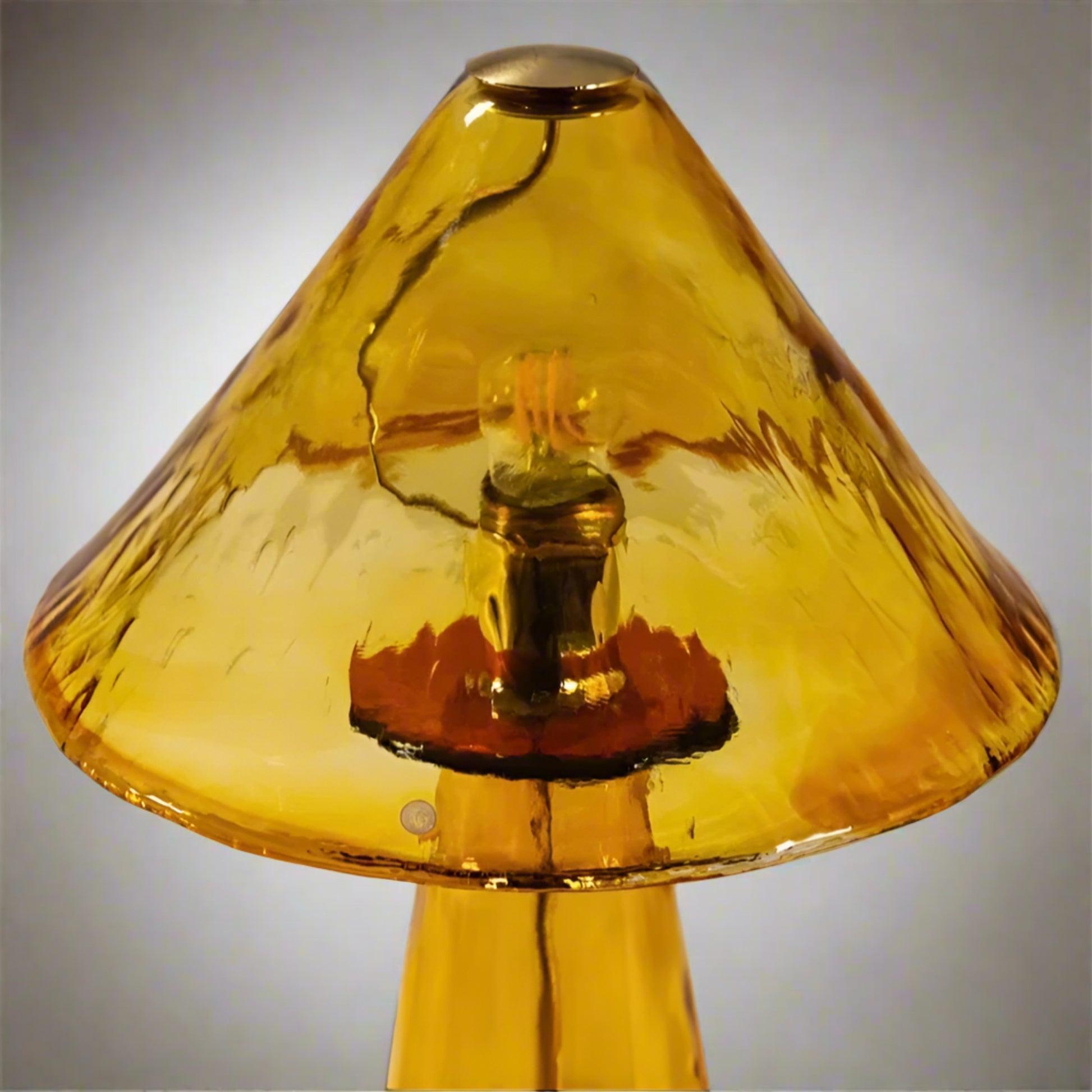 Amber glass lampshade with a light bulb inside on a white background
