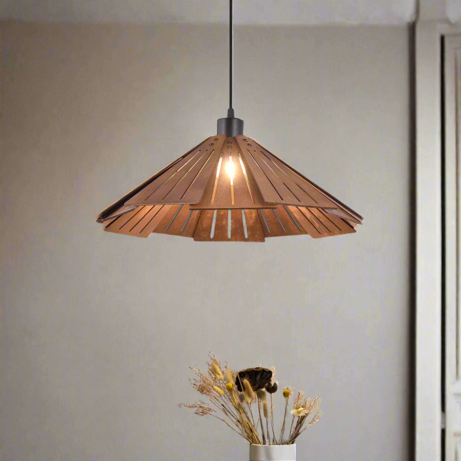 Wooden pendant light fixture in a room with a vase of dried flowers on a table.