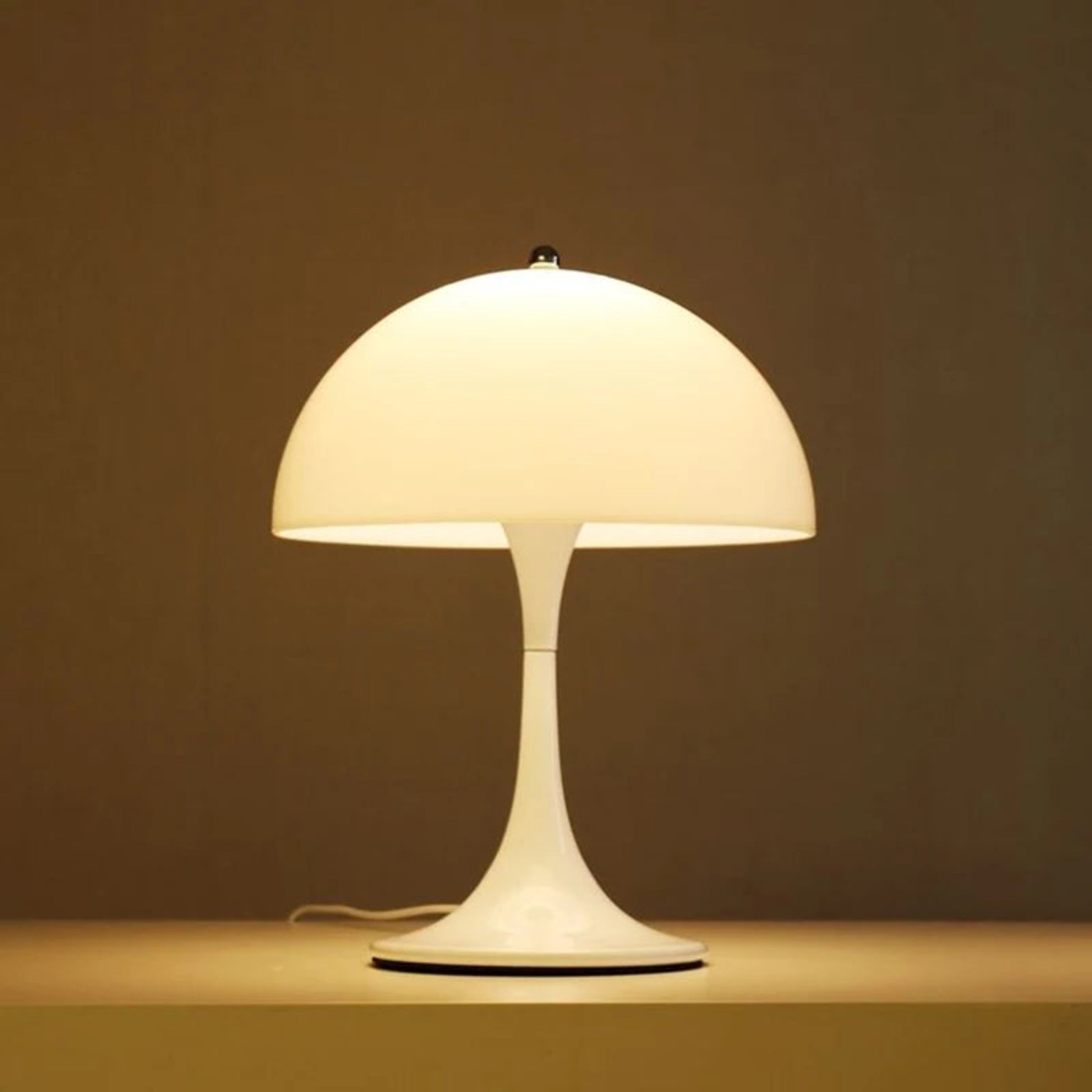 White table lamp on a brown surface with a brown background