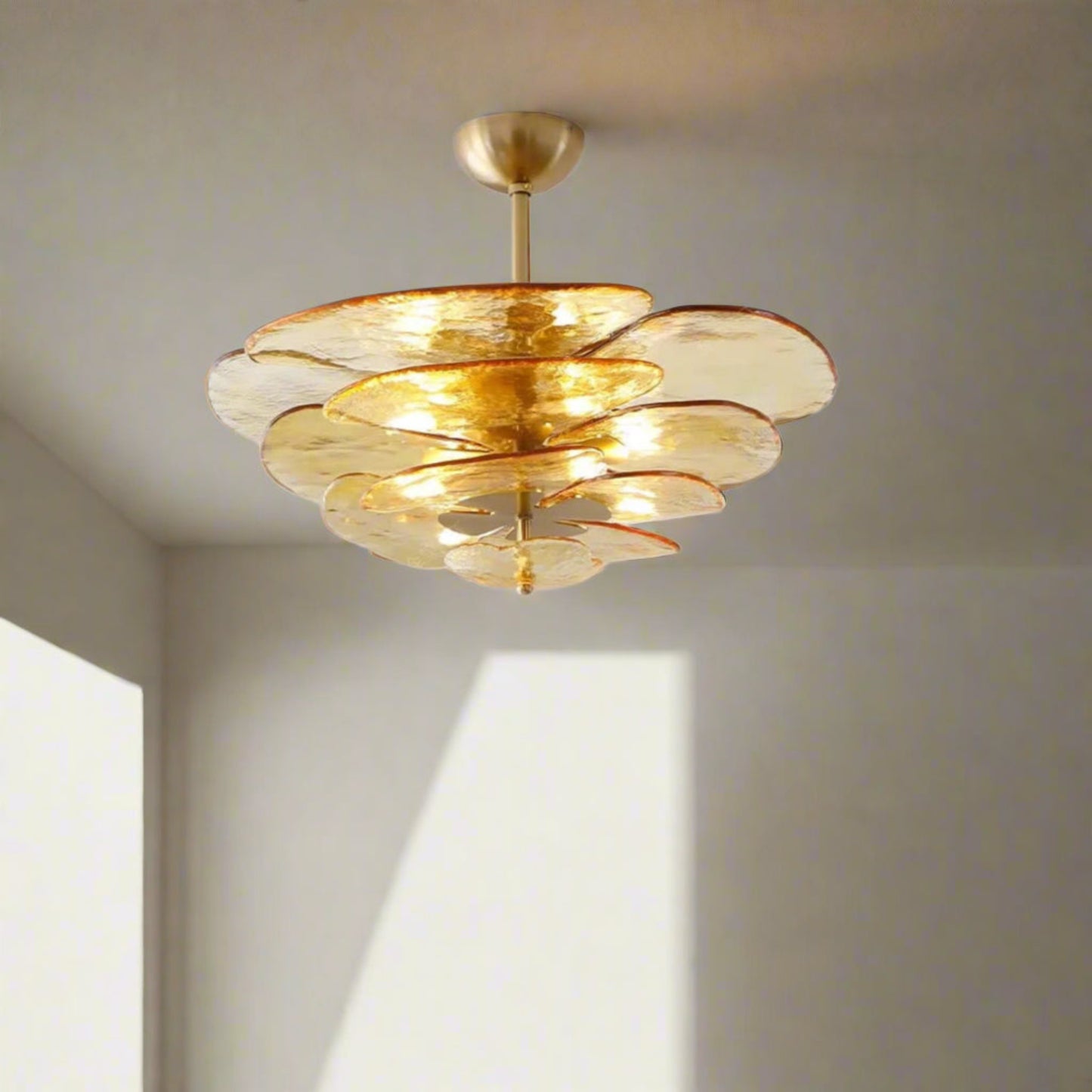Gold ceiling light fixture on a white wall