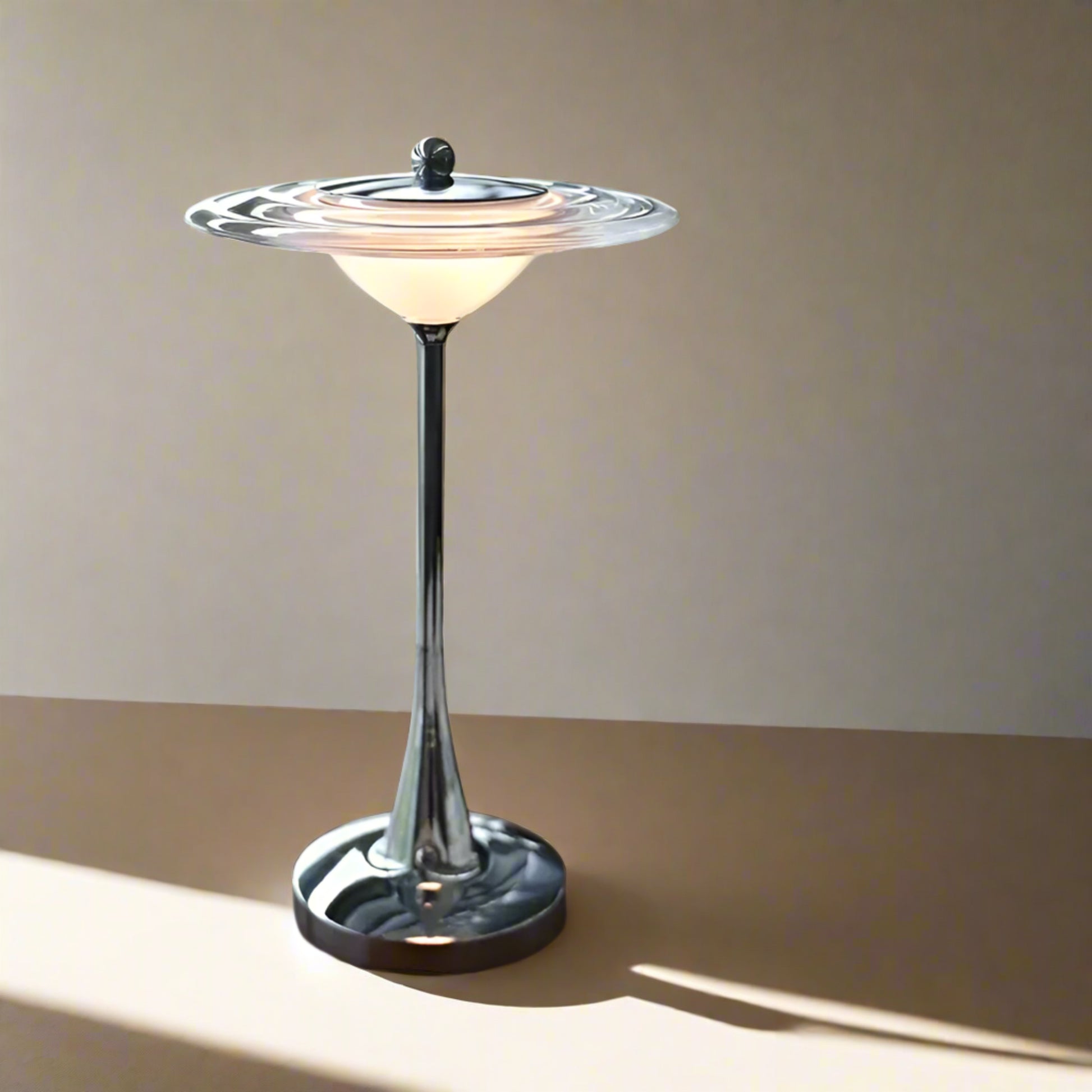 Decorative table lamp on a surface with books and a window in the background
