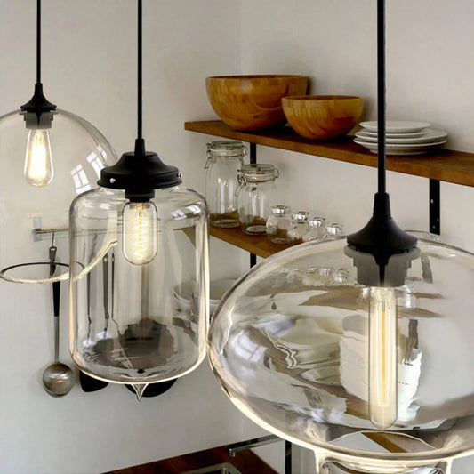 Modern pendant lights with glass shades in a kitchen setting.