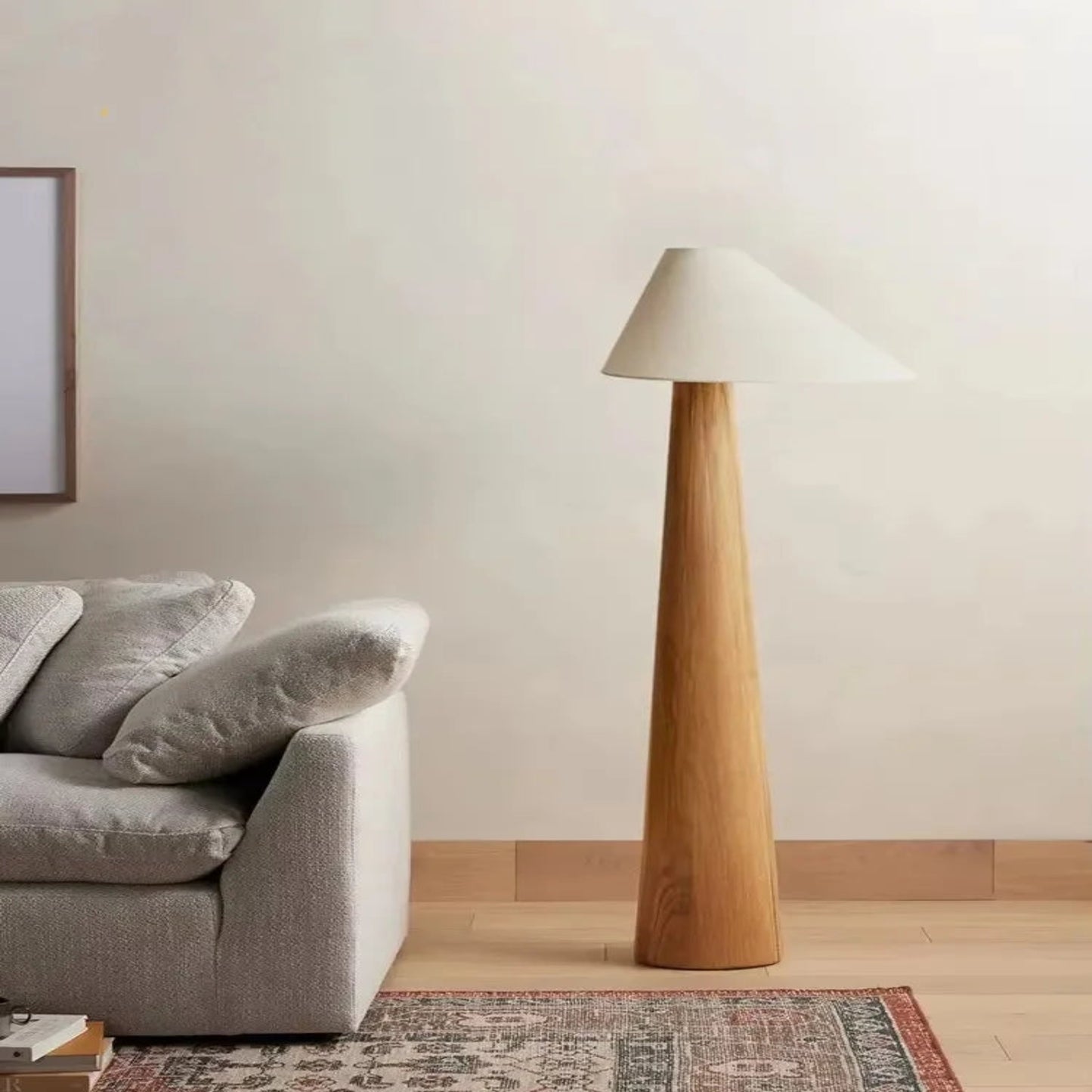 Modern living room with a gray sofa and a tall wooden floor lamp.