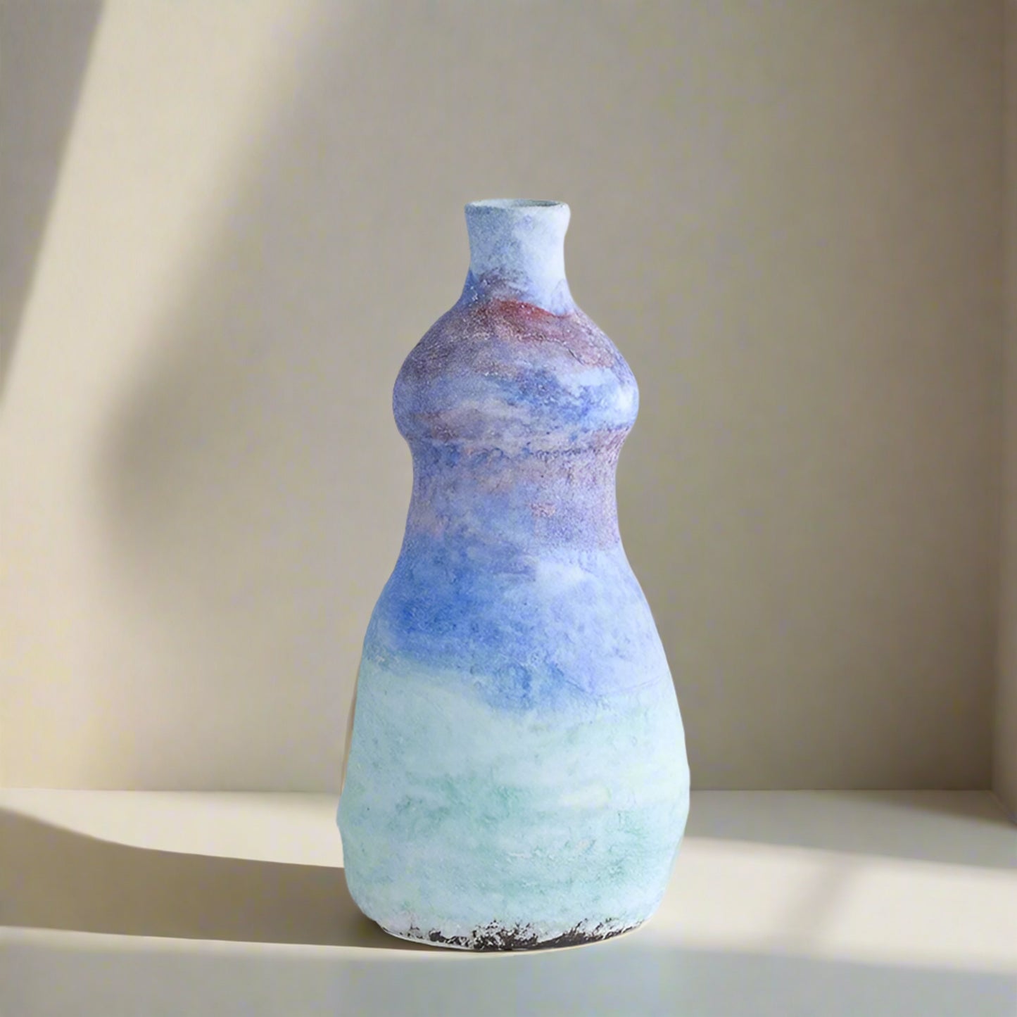 Multicolored ceramic vase on a light gray background