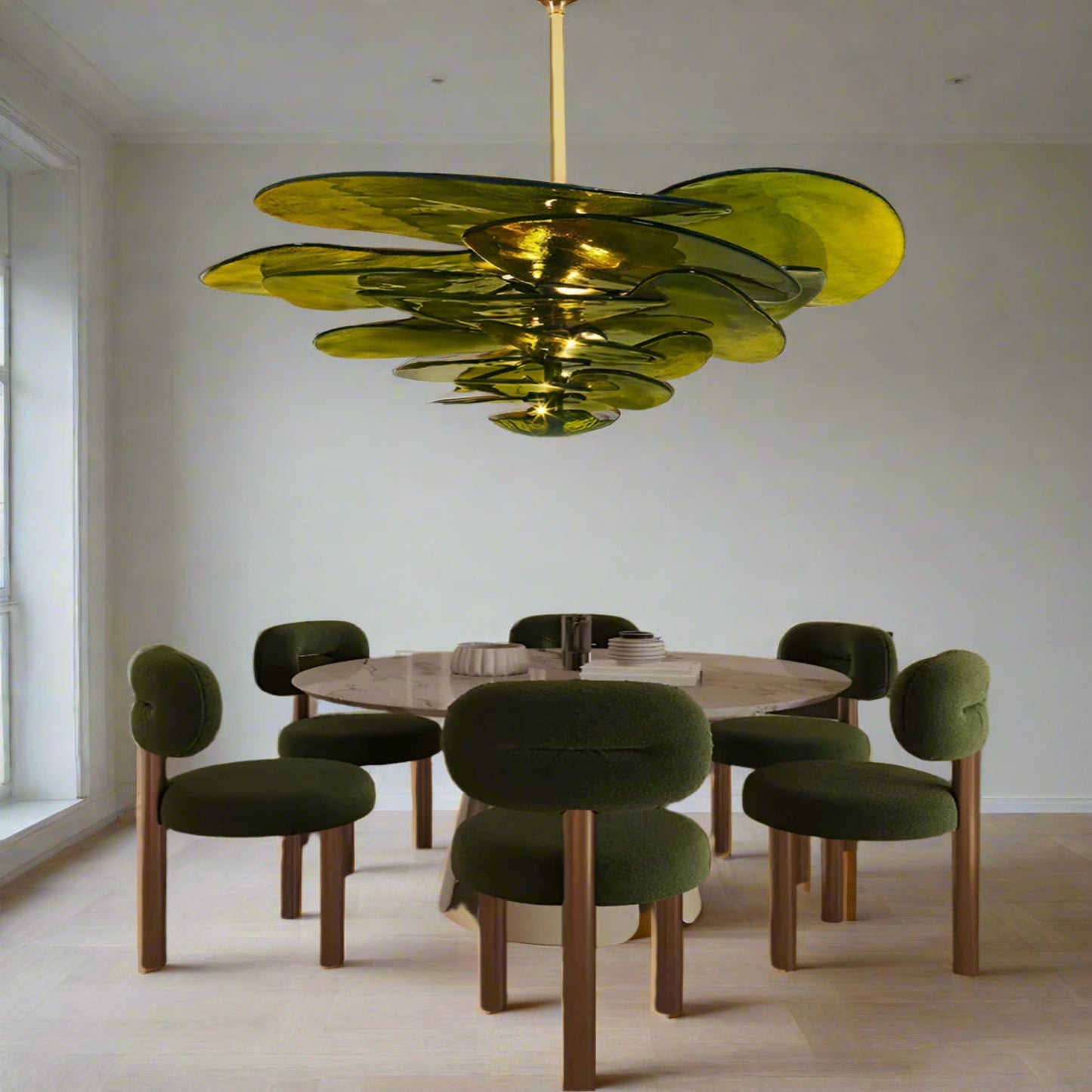Dining room with a modern green chandelier, round table, and green chairs.
